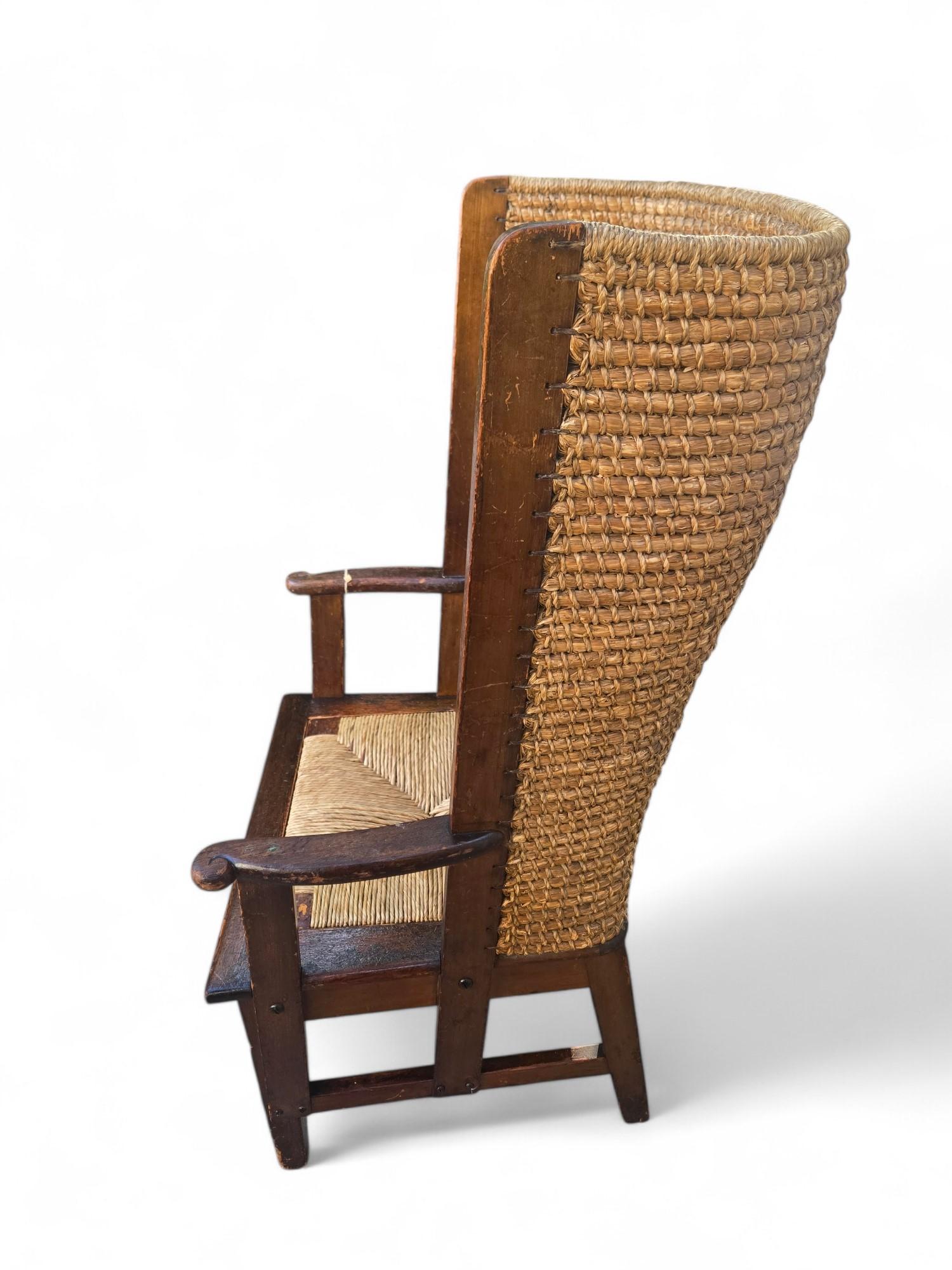 Antique rush woven Scottish fireside chair. This is an attractive Orkney chair, this oak piece has the signature woven winged back and rush seat. The charming traditional design comes from the islands to the north of Scotland, where they kept the