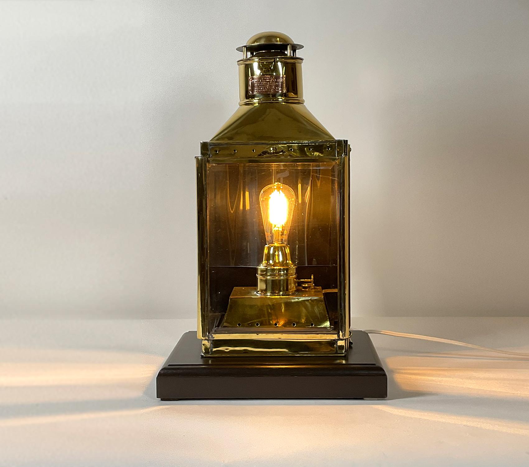 Solid brass cabin lantern from a yacht. Meticulously polished and lacquered. Fitted with a copper maker’s plate bearing maker’s name Emory Douglas Co. LTD. St James Street Glasgow Scotland, successors to Morgan and Weers of London. With hinged door