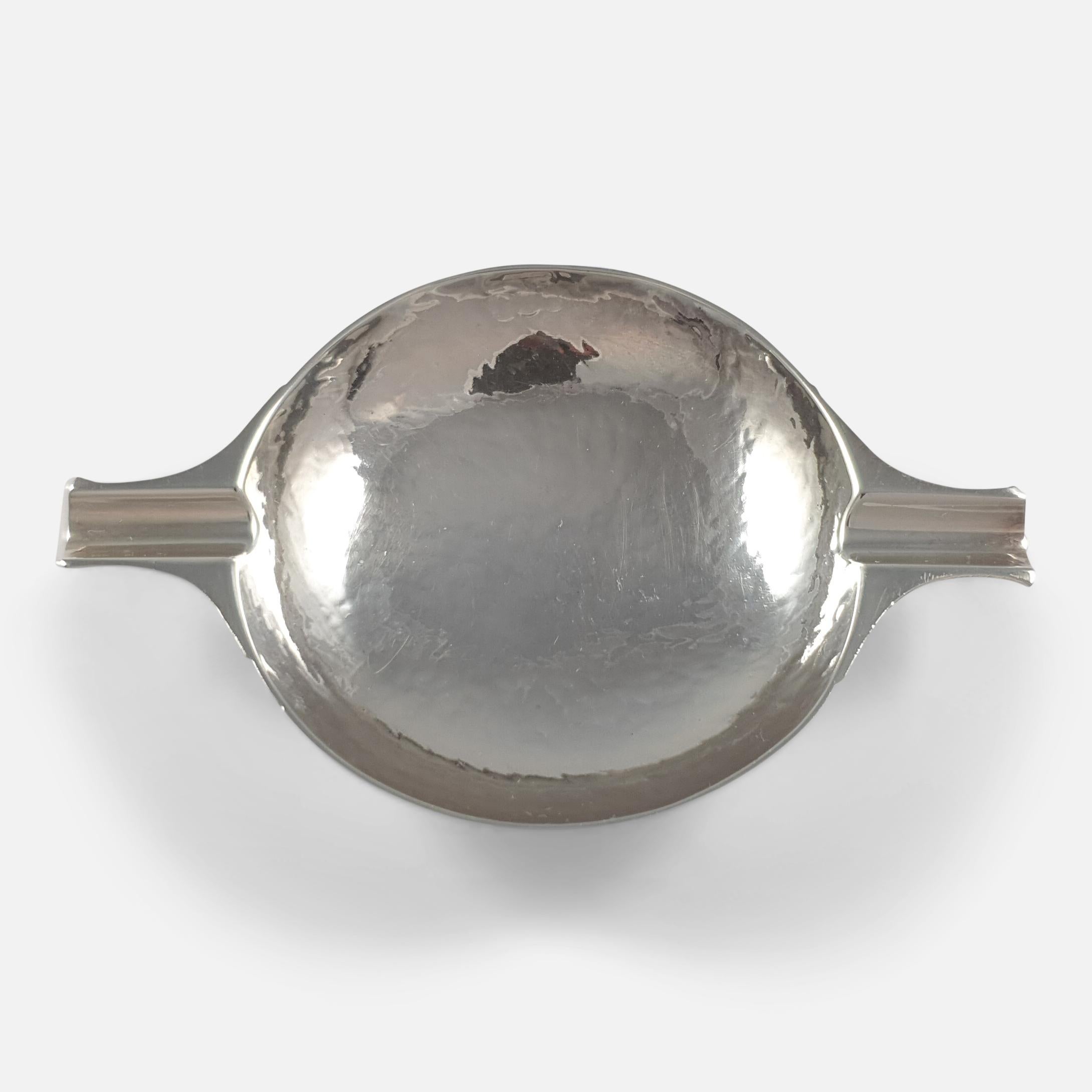 A George V sterling silver ash tray in the form of a small Quaich with a hammered finish. The ash tray is by William Robb of Ballater, with Edinburgh marks for 1924.

Assay: .925 (Sterling Silver).

Date: 1924.

Engraving: N/A.

Maker: William