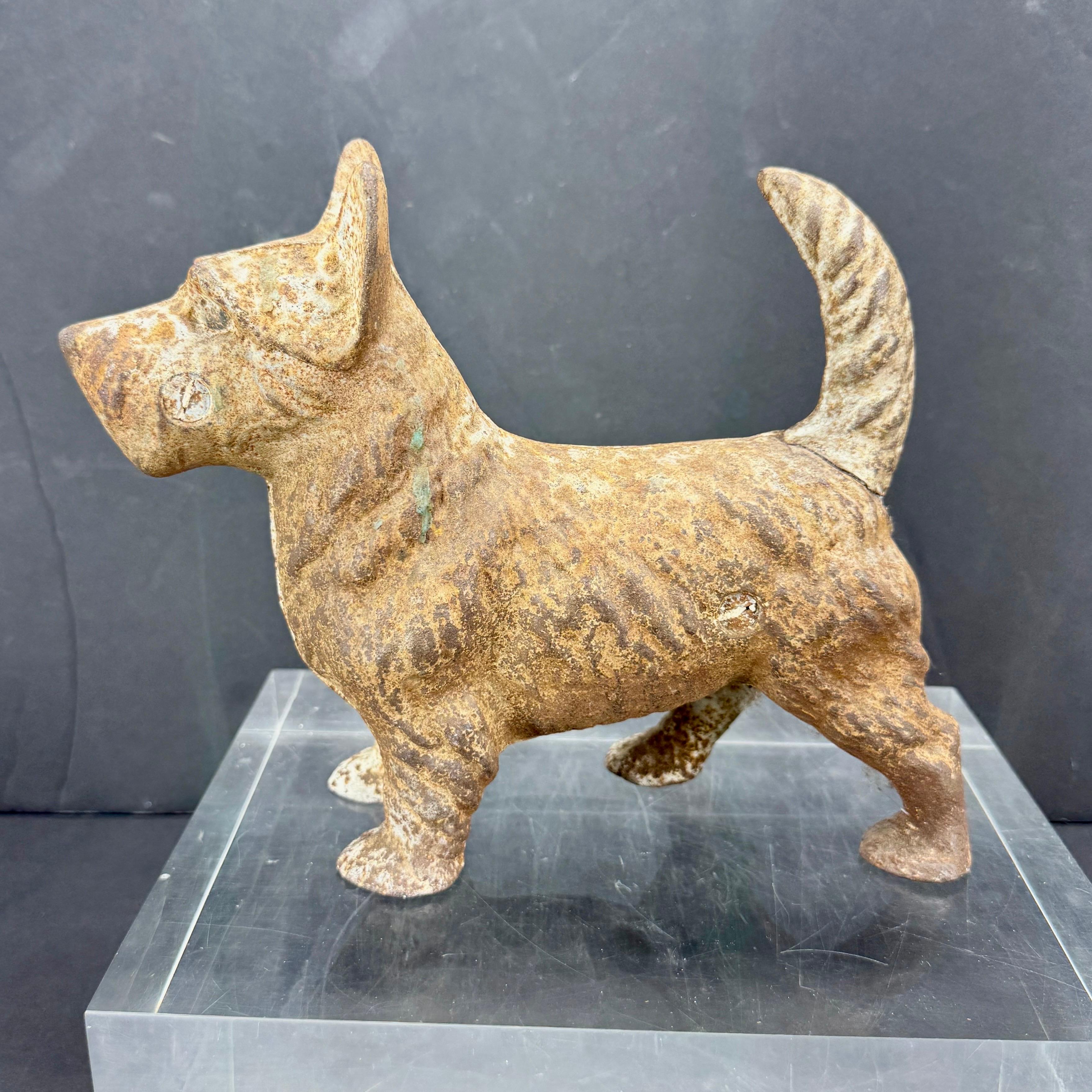 Cast Iron Doorstop Sculpture of a Scottish Terrier from England. This charming terrier has many functions. As a sculpture on a side table or used to keep open a door and add character to your home. Wonderful gift to add to a collection of these