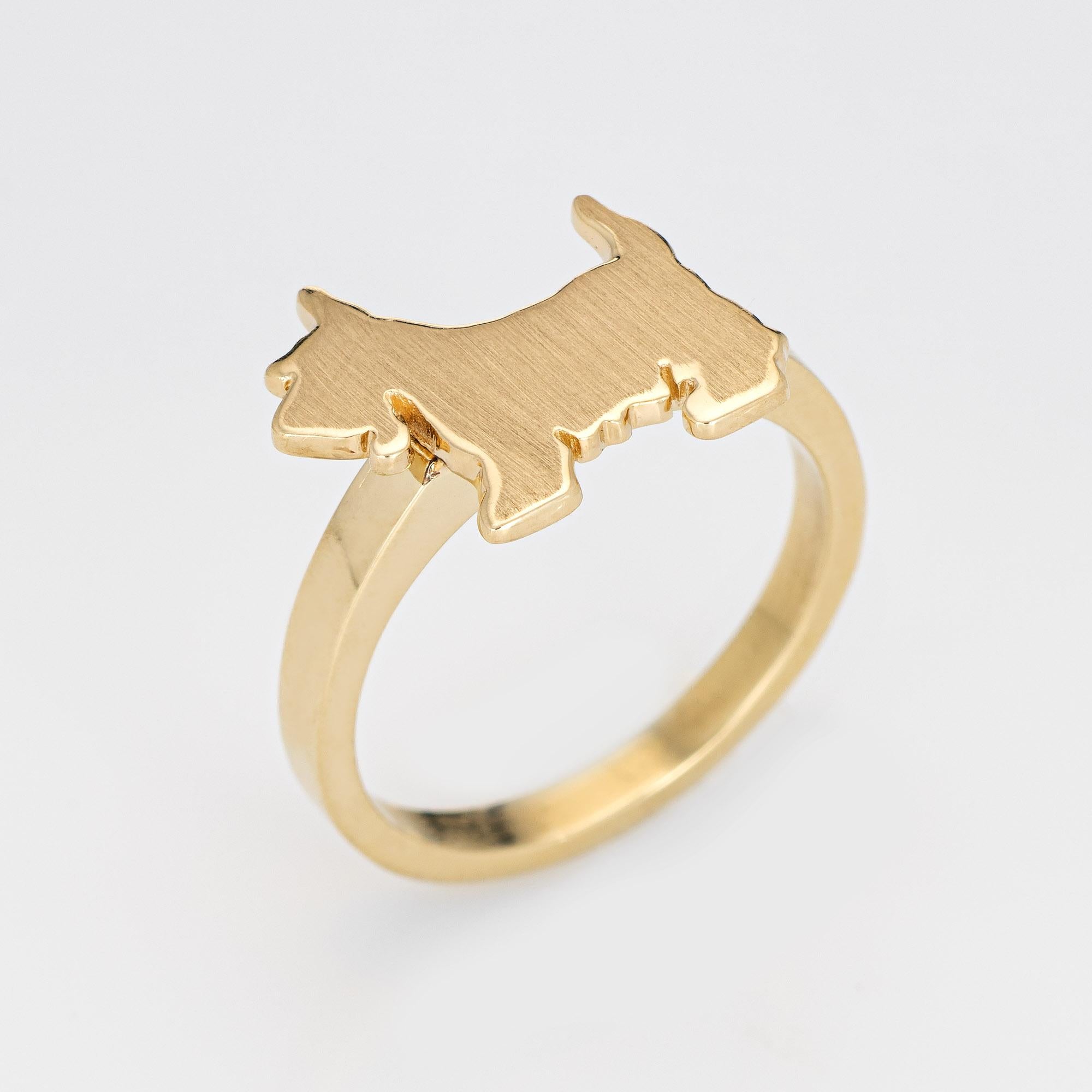 Originally a vintage stick pin (circa 1950s to 1960s), the scotty dog is crafted in 14 karat yellow gold.

The ring is mounted with the original stick pin. Our jeweler rounded the stick pin into a band for the finger. The beautifully detailed