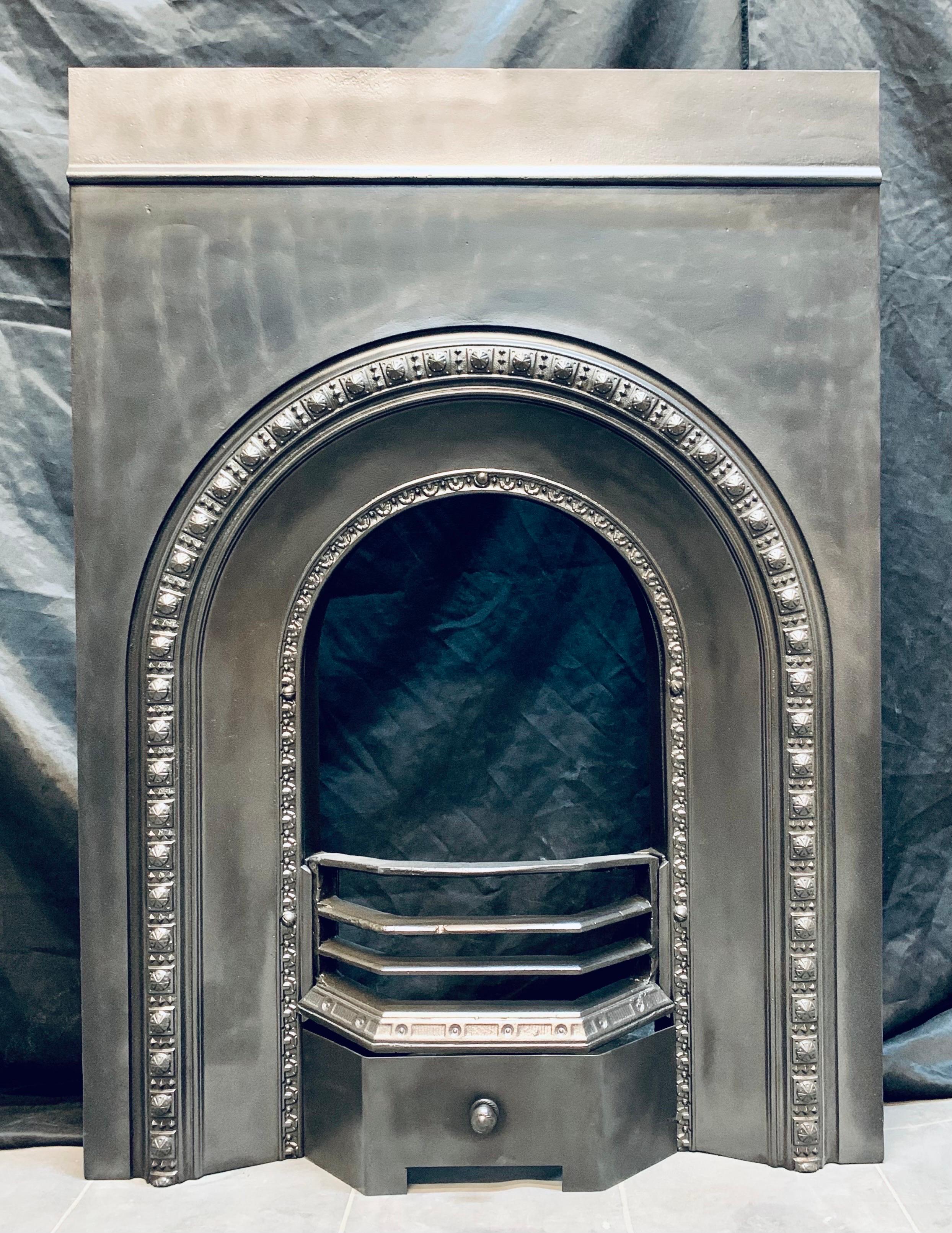 Scottish Victorian cast iron arched fireplace insert. A medium sized insert displaying good clean quality casting to the raised border. An historical second extension has been fitted to the top of the outer plate. This of course, could be removed as