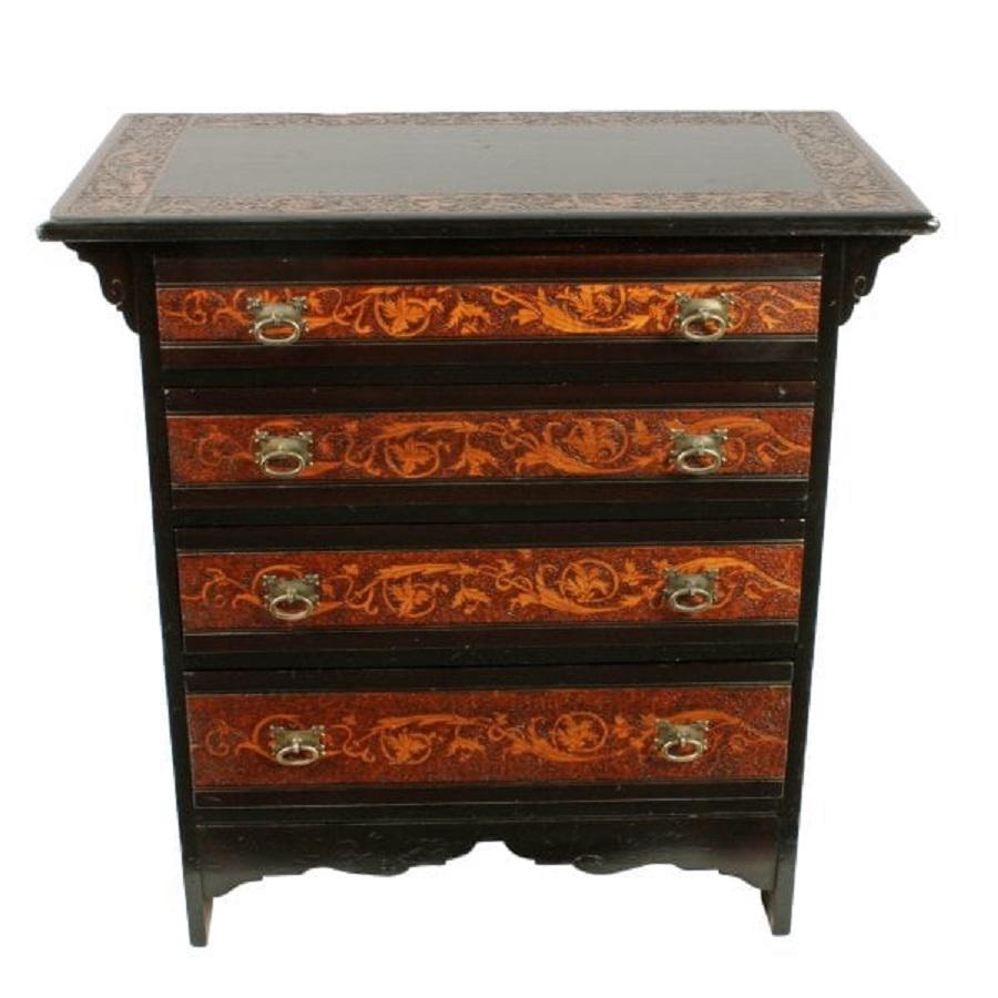 A late 19th century Scottish Victorian chest of drawers with poker work decoration.

The chest of drawers is from the Arts & Crafts period and has an ebonised finish with bands of poker work decoration.

The decorative pattern is made using the