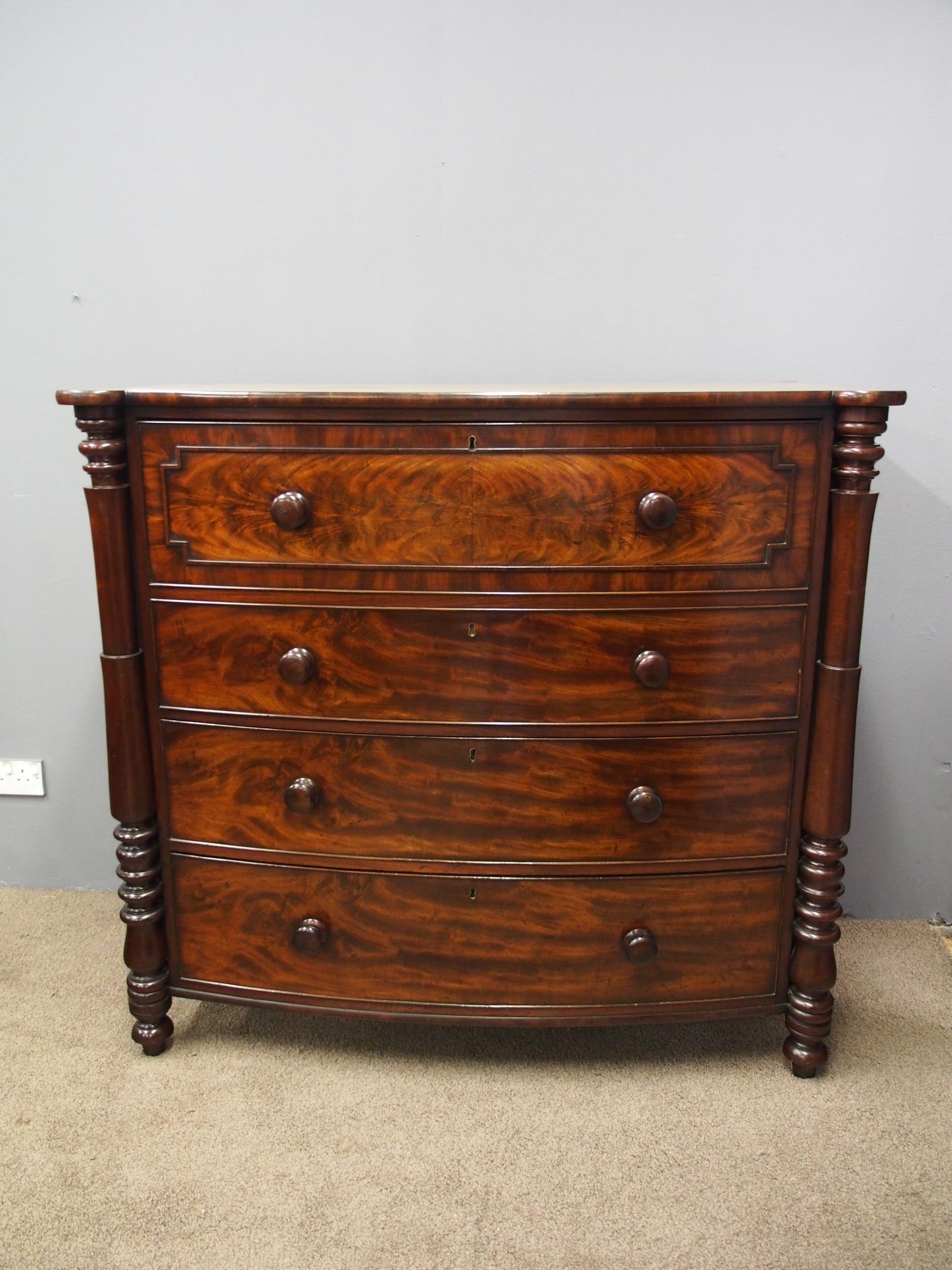 Scottish William IV flame mahogany, bow fronted, chest of drawers, circa 1835. With a configuration of four bow fronted drawers, all with double mahogany knob handles. The top two drawers are a single drawer, and has a fielded panel with shaped