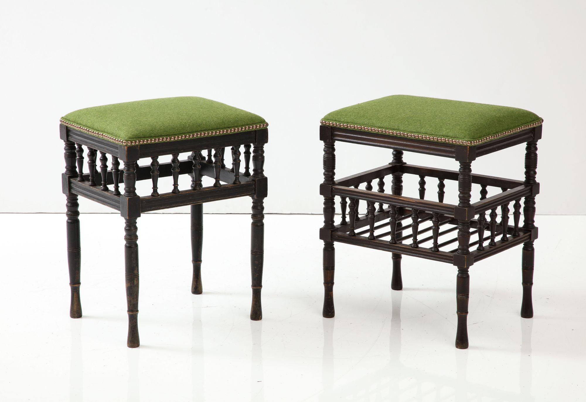 Two early 20th century aesthetic movement stools in ebonized beech with new lettuce green 100% scottish wool upholstered tops with brass stud detailing, both with box spindle stretcher galleries, one with a lower tier and one without.  Can work as a