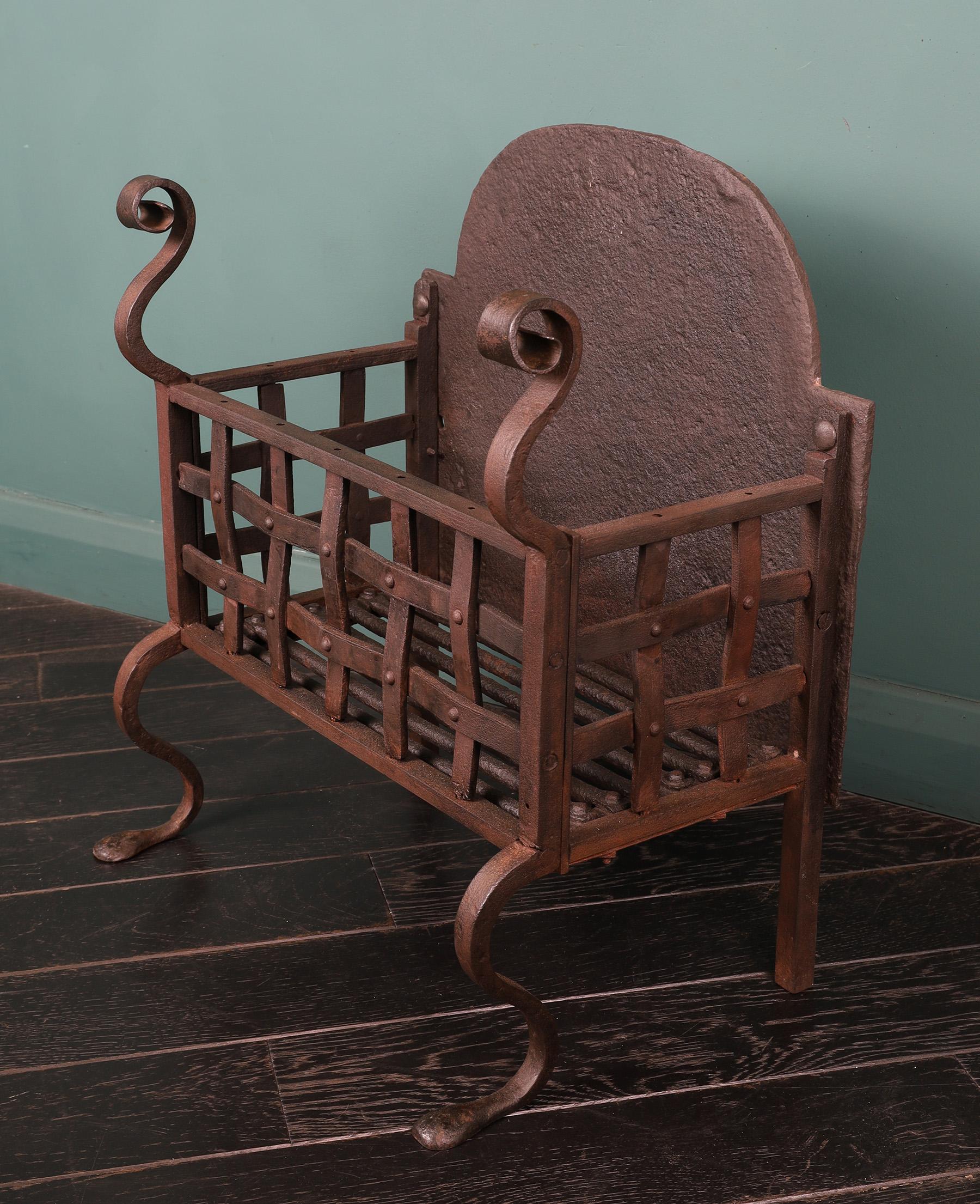 A Scottish wrought-iron fireplace grate basket with rivet-work lattice front, scroll finials and shaped legs. Waxed finish. Restored.
Height of burning area: 6 1/2″
Width at feet: 18 1/2″
Circa 1900