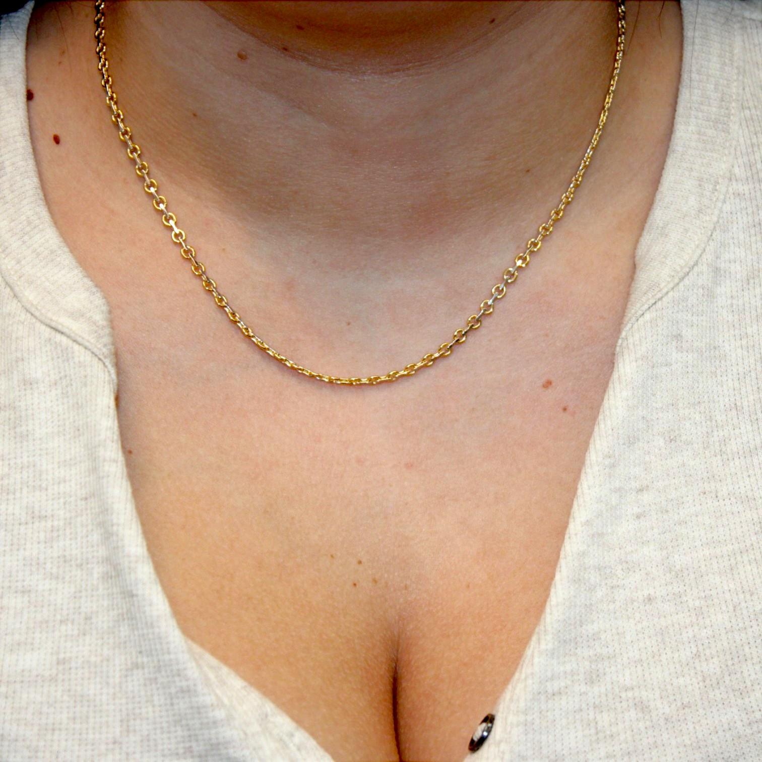 A perfect harmony of contrast and craftsmanship. The Scout Chain by Mountain Song Jeweler blends radiant 18k yellow gold with cool, polished 18k white gold in an artful mix of 4 mm circular links. At 18 inches, this piece sits just right on the