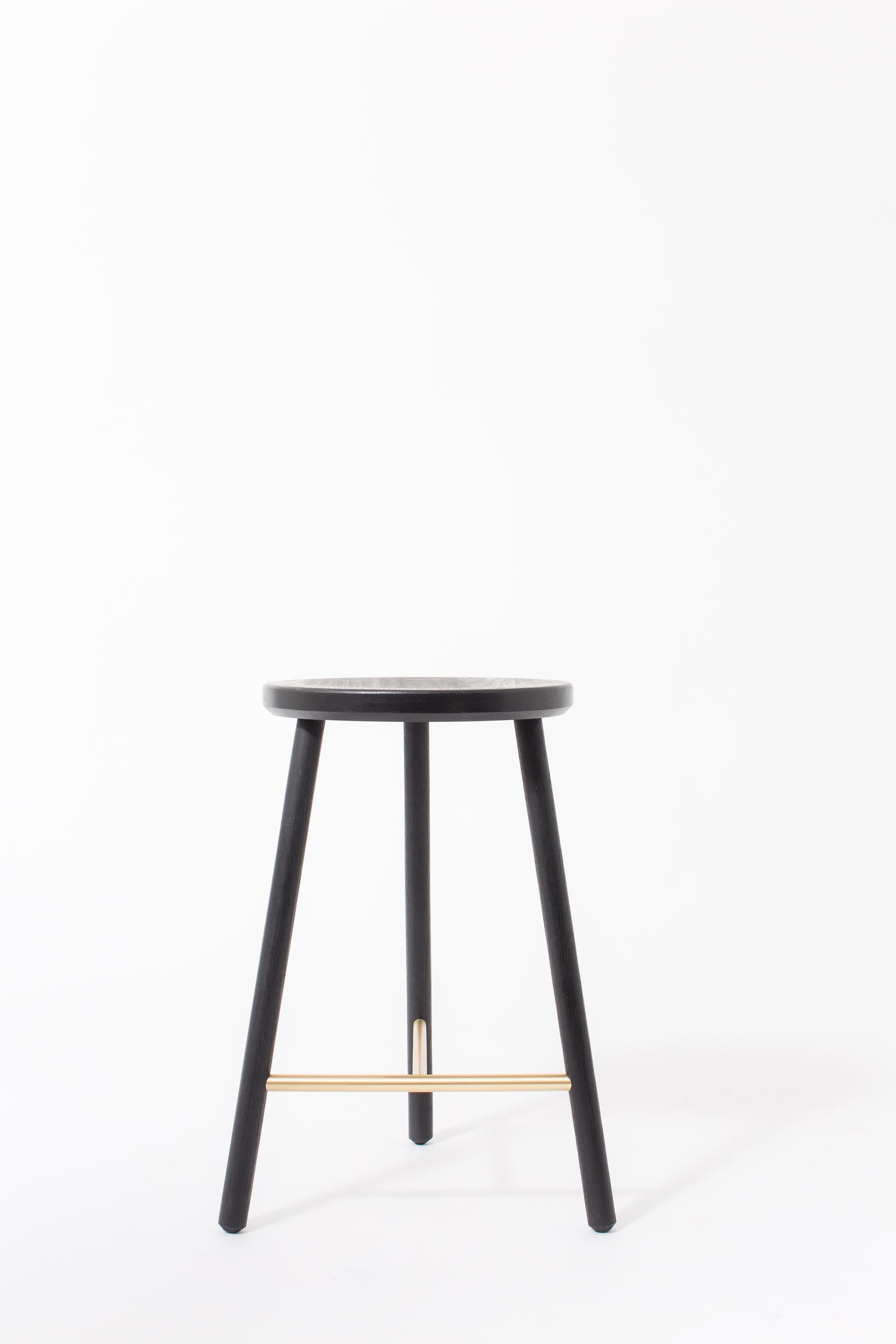 The scout stool has a slim design, allowing it to be tucked into small spaces with a minimal footprint.

Shown in ebonized/blackened oak and satin brass. Domestic hardwood species available include white oak, walnut, maple or ash. Hand rubbed oil