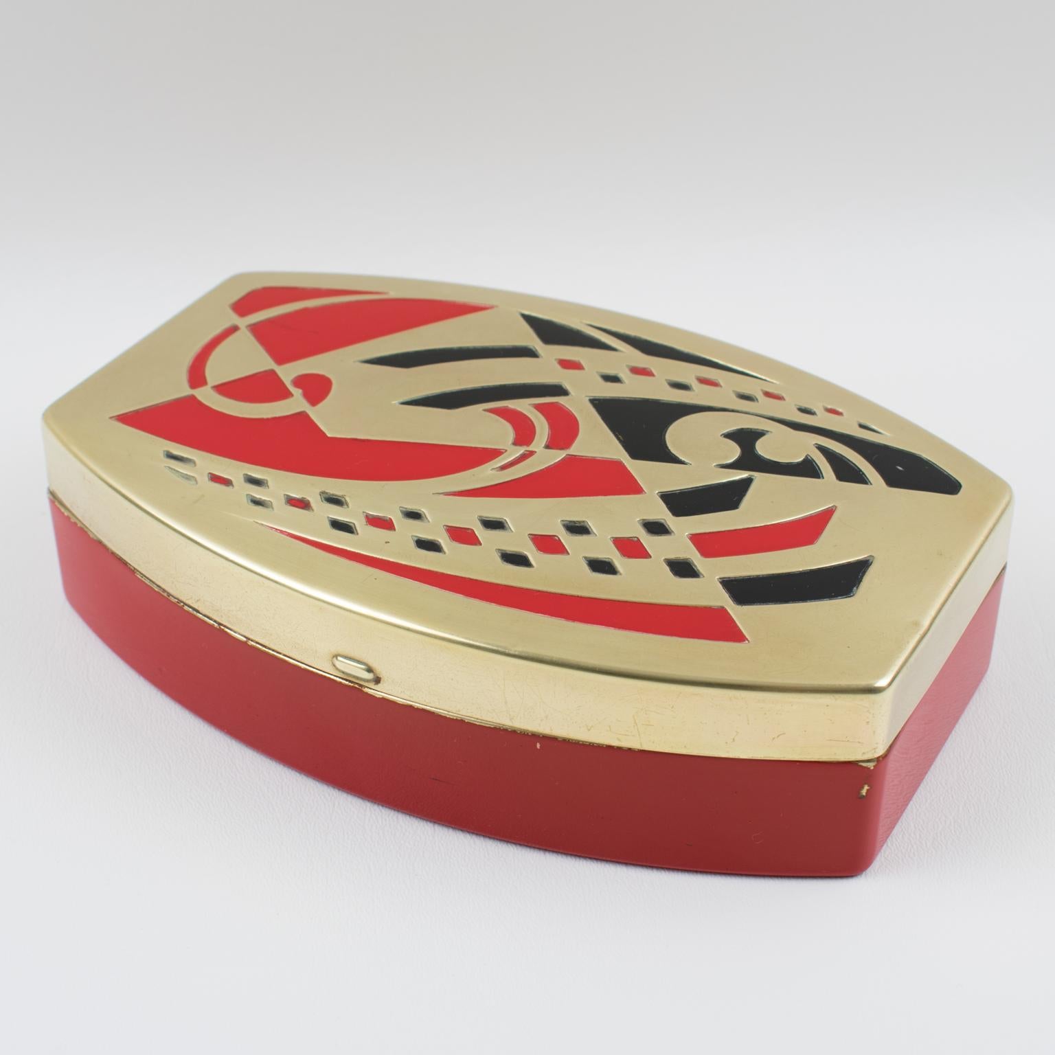 Stunning Art Deco decorative jewelry or vanity box with embossed lid made by Scovill, USA. The box features a red bottom and a gilt color lid with embossed red and black abstract geometric design on the top. Marked at hinge: 