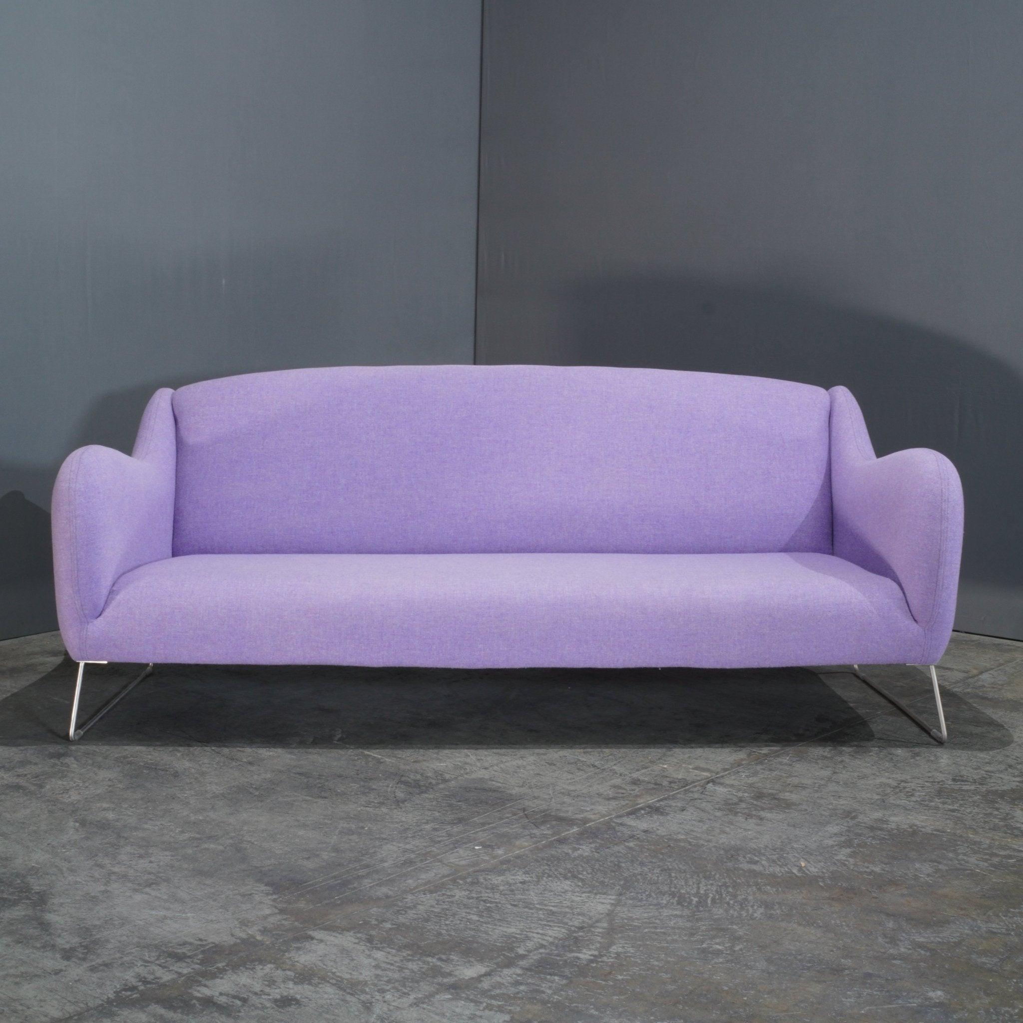 The SCP Baude Lilac Three-Seater Sofa by Matthew Hilton is a refined piece that seamlessly blends comfort with contemporary style. Upholstered in a soft lilac fabric, this sofa offers a generous and inviting seating experience, perfect for modern