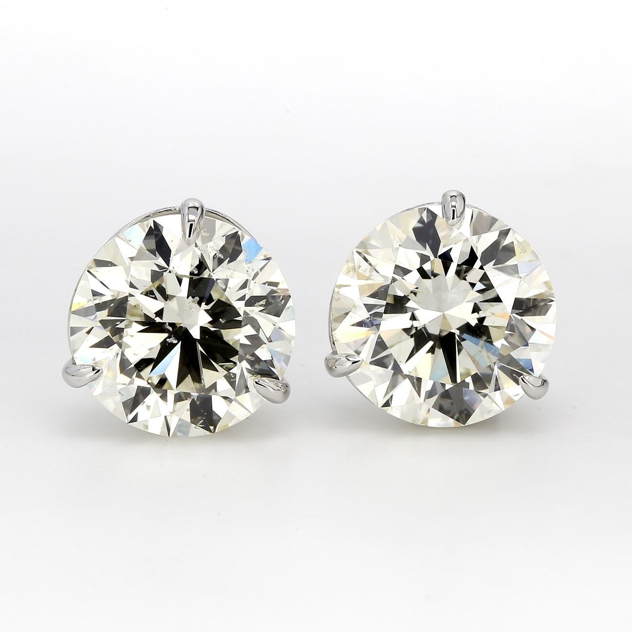Screwback stud earrings in white gold with prong set GIA certified M/SI2 round diamonds.  D7.06ct.t.w.
