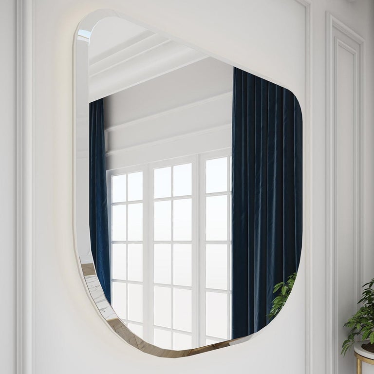This mirror embodies pure functionality and minimalist design. Versatile and elegant in its simplicity, the round corner shape is entirely unadorned. Framed in satin brass-finished metal, this mirror will be equally stunning in a bathroom, living