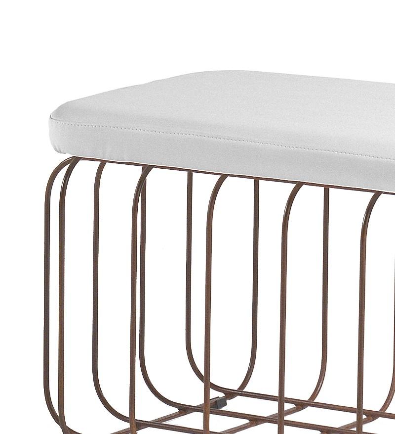 Inspired by 1950s and 1960s wire rod furniture, this versatile pouf has an open rectangular base made of solid iron wire rods with rounded corners in a natural rust finish, topped with a white ecopelle (recycled leather) padded seat. Stylish and