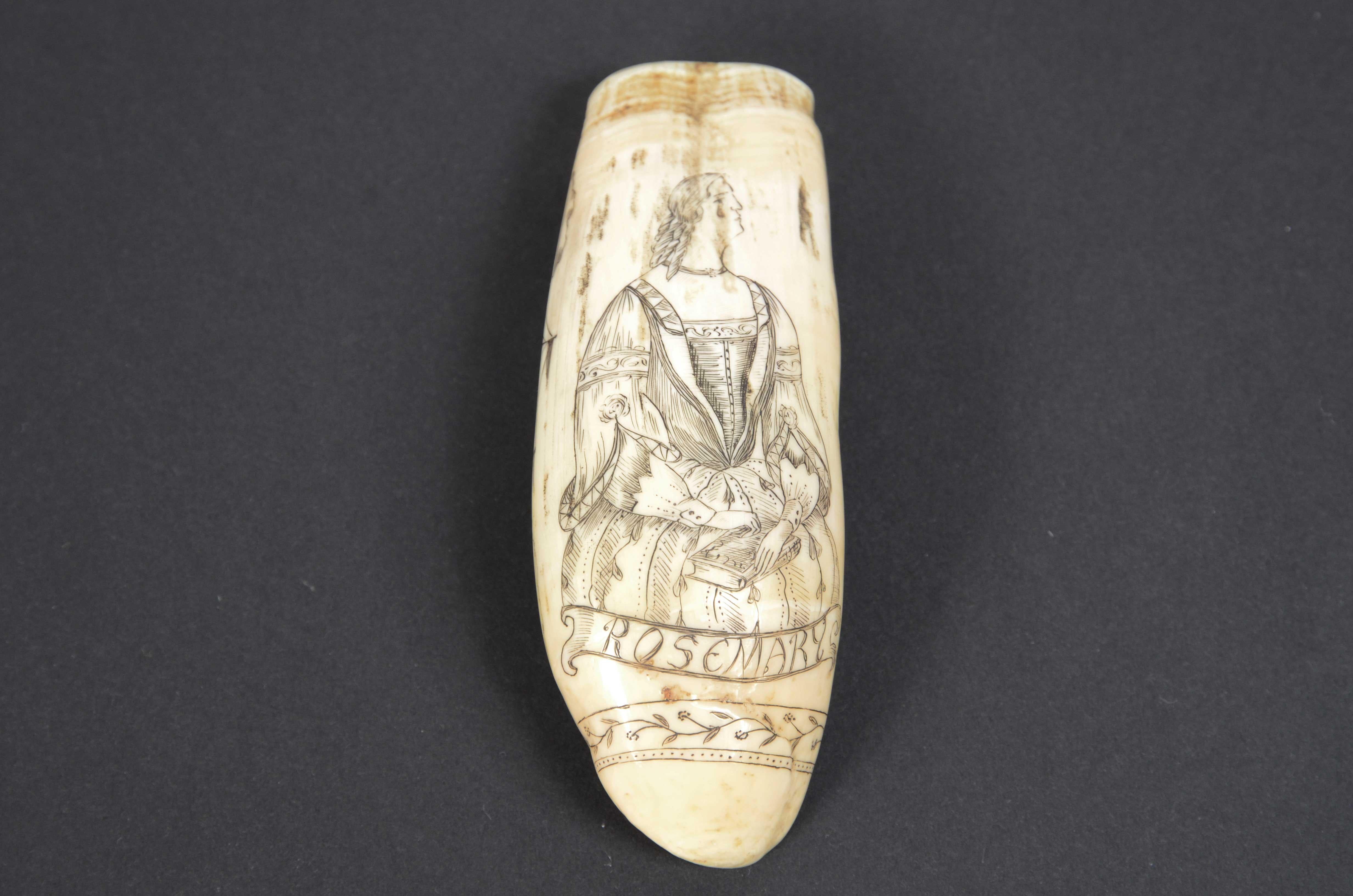 Scrimshaw of an engraved whale tooth, fine workmanship datable to around mid-19th century, length 11.7 cm, depicting whaler with men aboard, boat  rowing with 6 whalers one of them in act  of harpooning a whale  and three whales. On  back of the