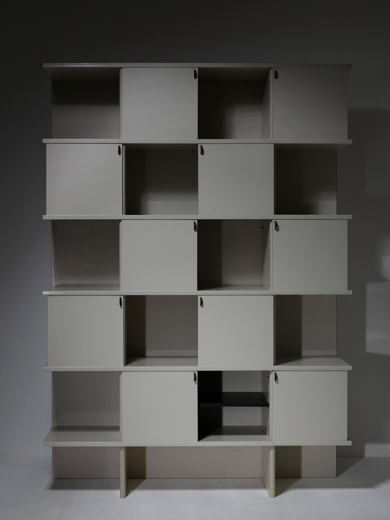 Rare Scripta bookcase by Giovanni Carini for Planula.
Five pairs of sliding doors allow to create different graphic effects based on squared shapes.