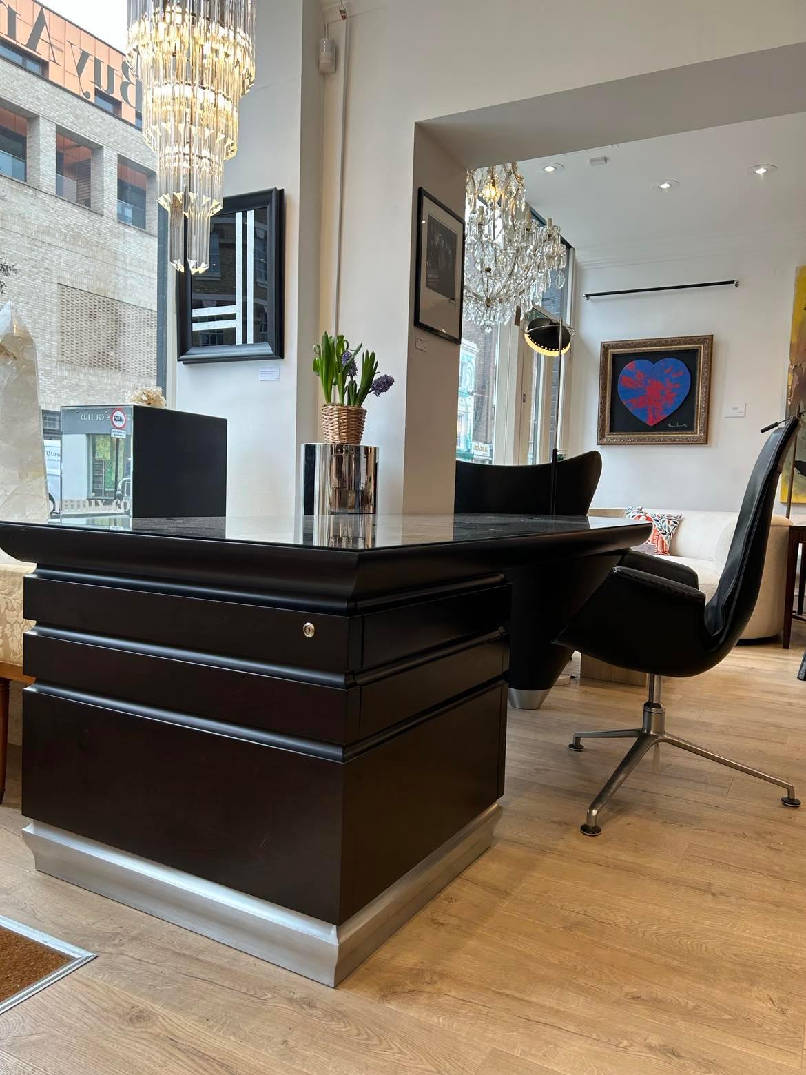 Scriptor Desk By Giorgetti In Macassar Ebony, designed by Leon Krier, 2004. 

This executive desk features ebony wood and a glass top, set on a cone shaped leg and chest with three lockable drawers.

RRP from new £22,000 - In very good pre owned,