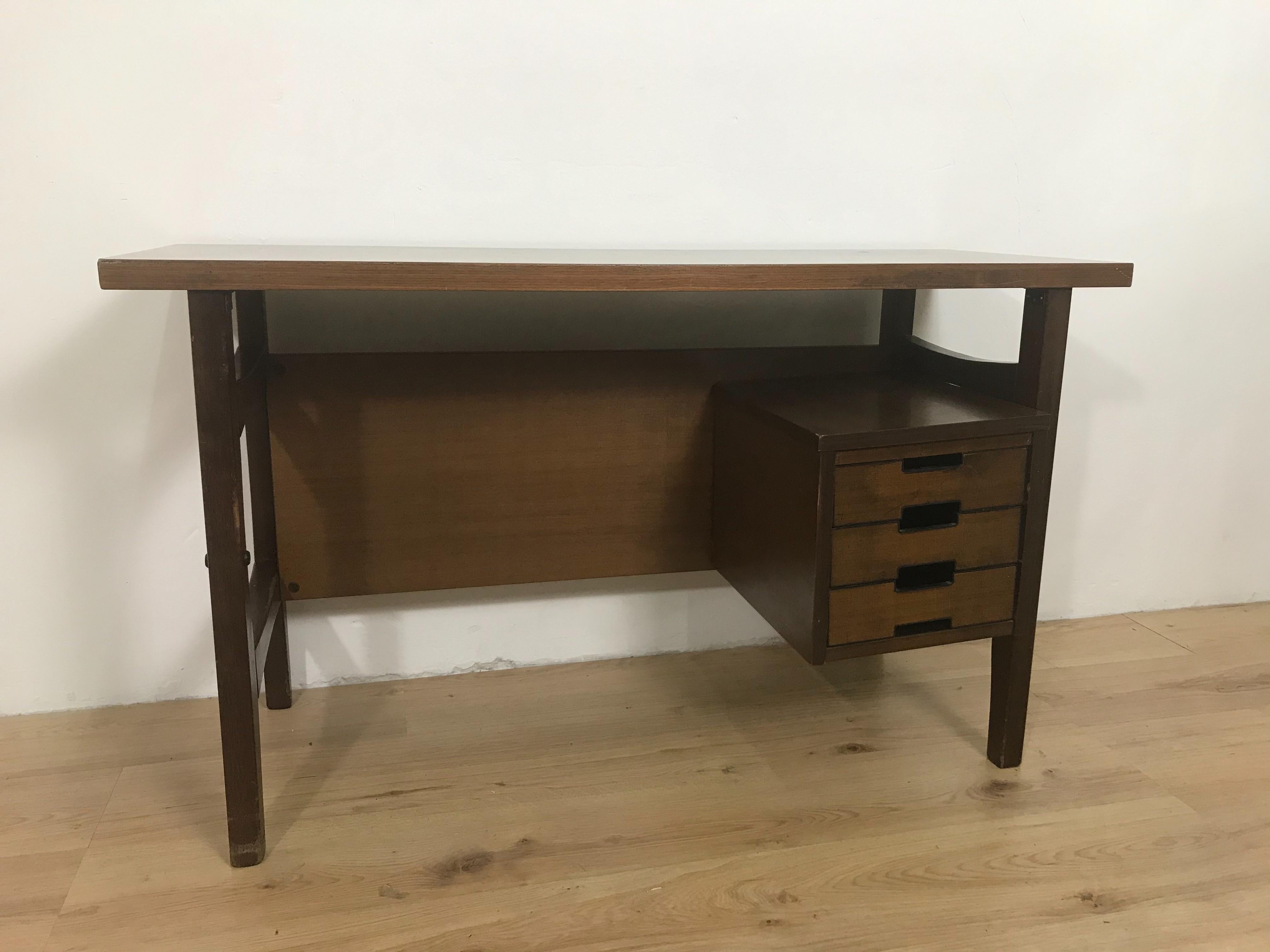 Wooden desk, with three drawers produced in Italy in the 60s by the Schirolli company based on a design by Giò Ponti, the desk is in good condition, it shows some signs of wear due to time and documented in the photos. 
Gio Ponti, is considered one