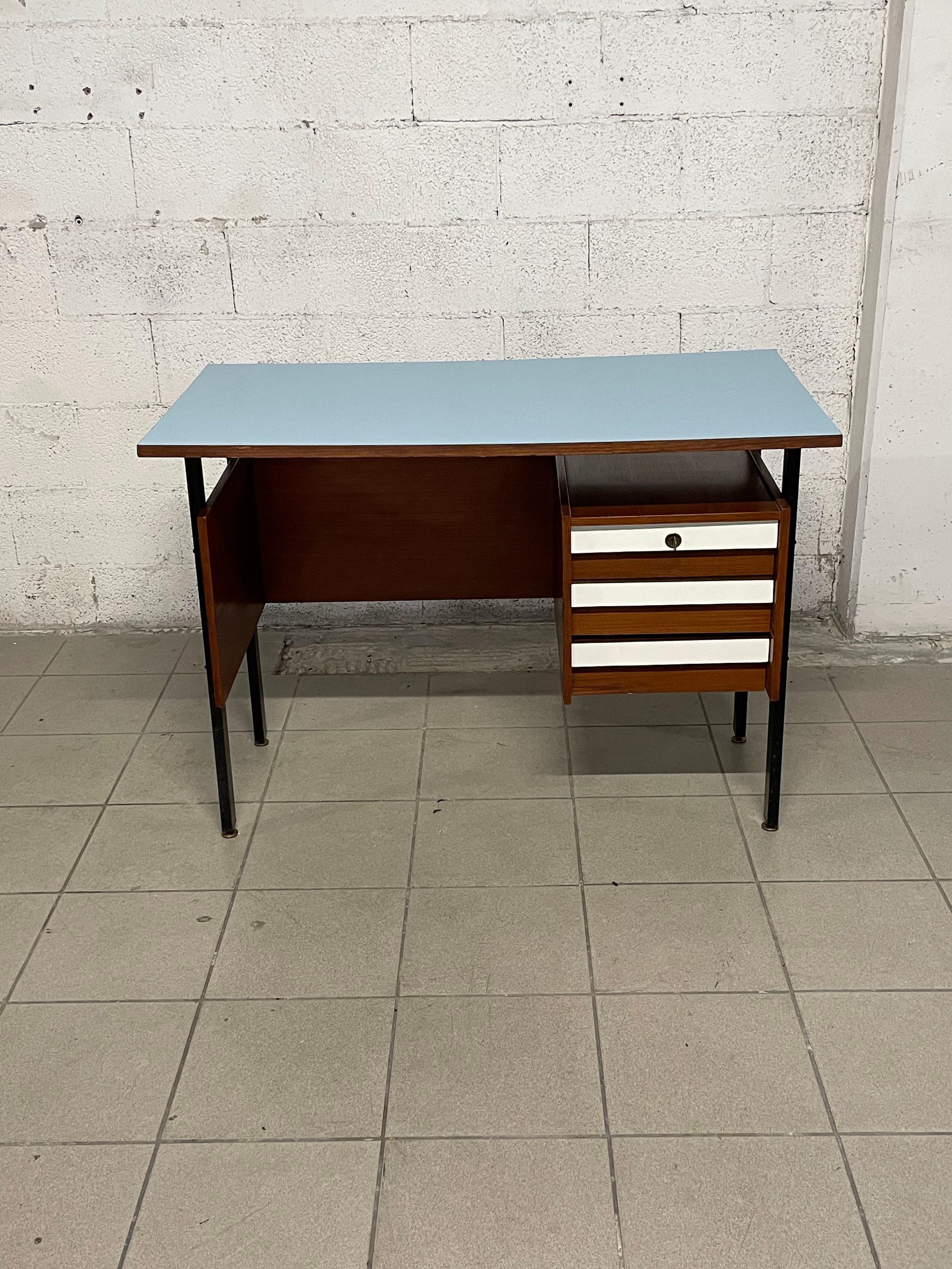 1960s teak wood desk with blue formica top.

On the right side are three small drawers with white formica fronts.
Black iron supports with adjustable brass feet.

The desk has been recently restored and is perfect for a bedroom set or even as an