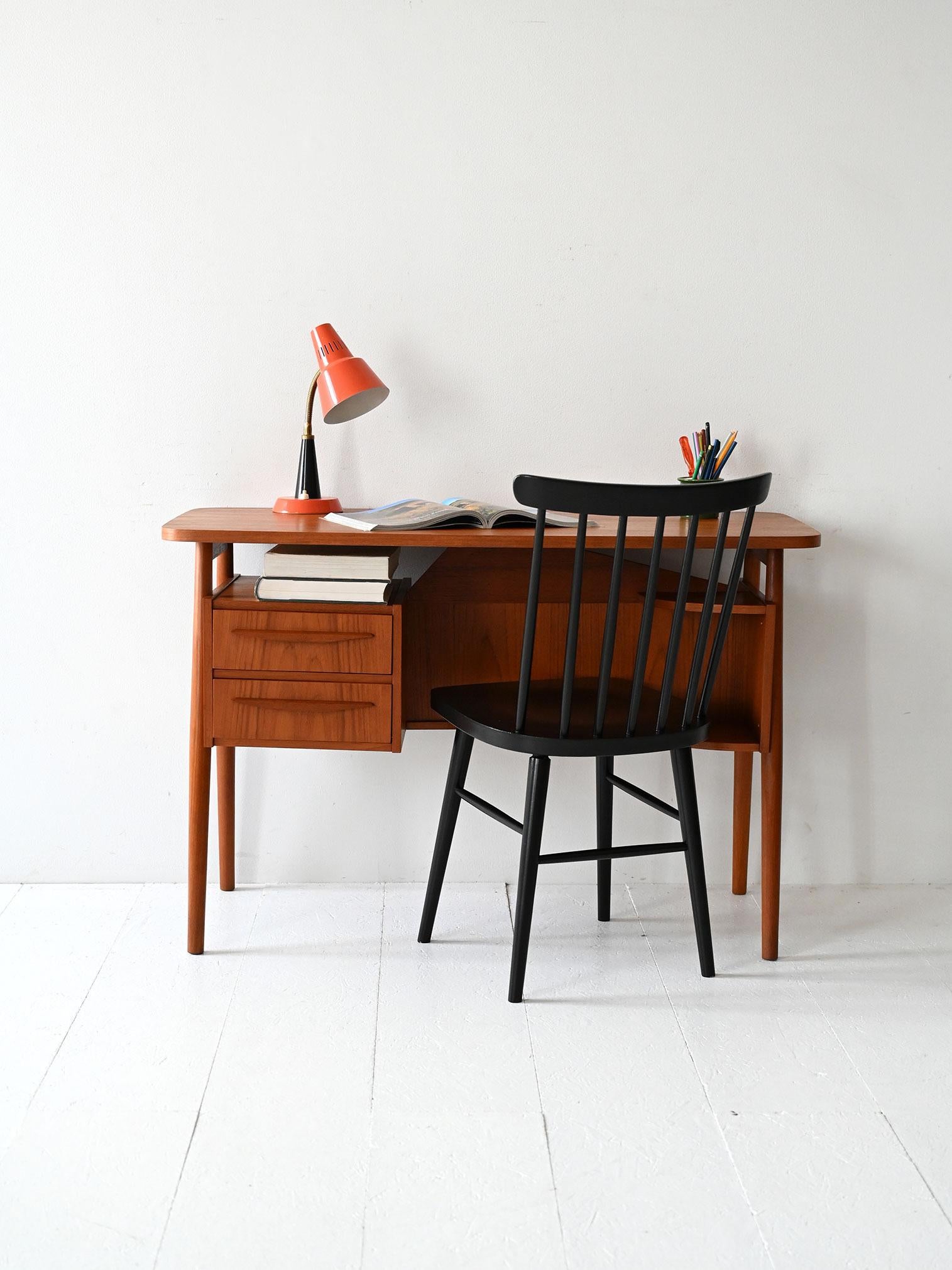 Teak desk with finished back, carved drawers and open compartments. Design by Gunnar Nielsen for Tibergaard.

Teak desk designed by Gunnar Nielsen for Tibergaard, Denmark, 1960s. The lightweight top with rounded corners rests on tapered legs. Three