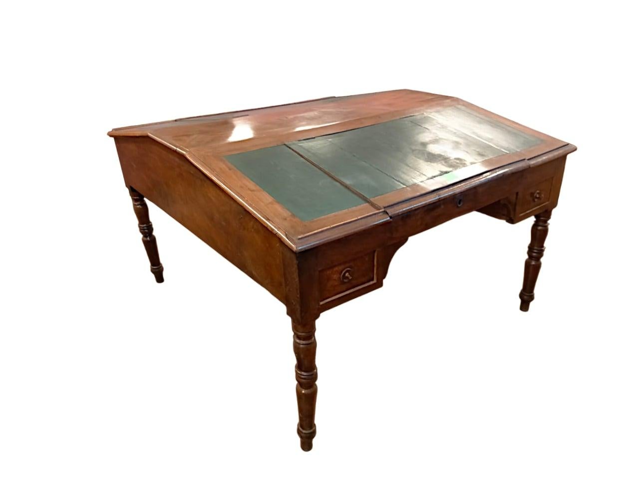 Double desk with opening desks

Double desk with tilting and opening desks, inside two large compartments, 
Each side of the desk has 2 drawers.
The cabinet is solid walnut, in first patina, circa 1850.
Turned legs.
Epoch: ca. 1850.

Measurements: