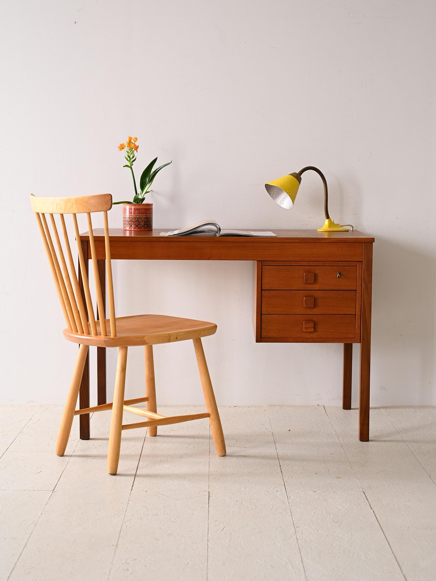 Vintage original 1960s teak desk. This charming piece of furniture embodies the simplicity and practicality typical of Scandinavian design. The compact structure and minimal lines give the desk a light, modern look that is perfect for smaller