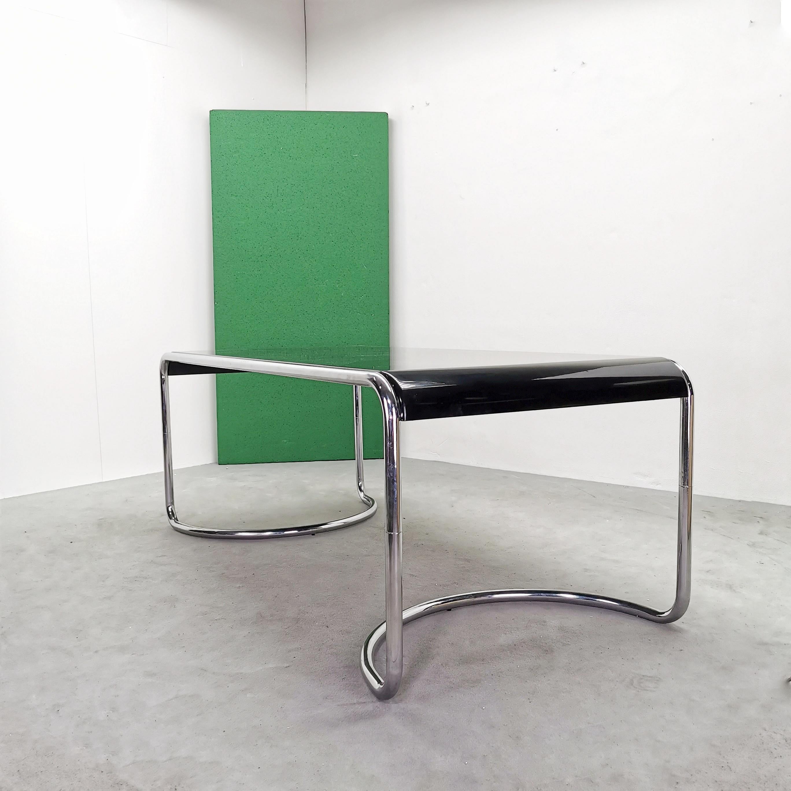 Rare Desk Table model Febo designed in 1970 by G. Stoppino for Driade. Chrome-plated tubular frame and lacquered curved wooden top. 
The table is in very good condition
the chrome structure has no defects
the plane shows some superficial signs of