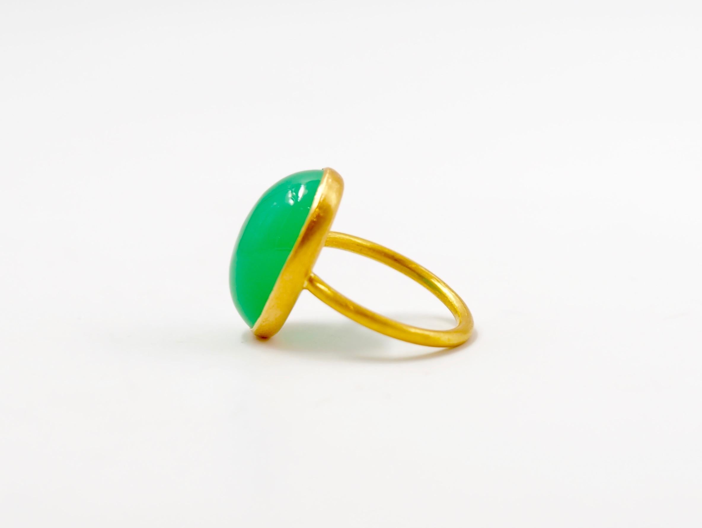 This simple ring by Scrives is composed of a large green chalcedony cabochon of 11.25 cts. 
The stone is set in a 22kt closed gold setting.
This chrysoprase is natural, not dyed and has natural & typical small inclusions.

This ring is handmade with