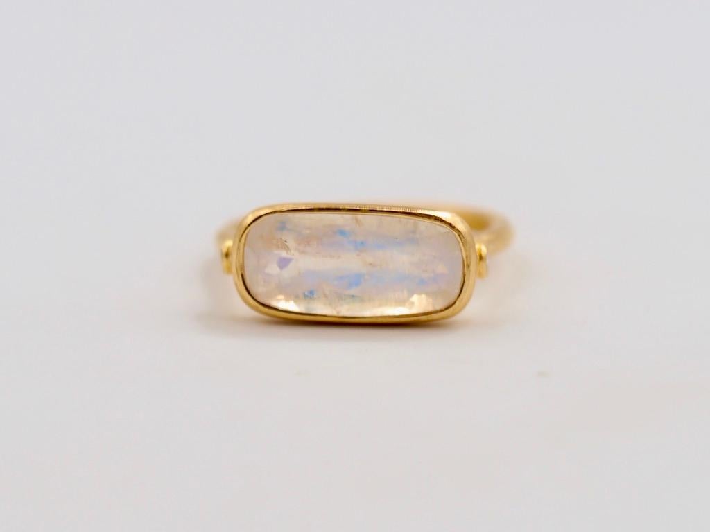 This delicate ring by Scrives is composed of a faceted milky moonstone of 3.28 cts and 2 small white diamonds on the side. The moonstone is faceted in a rectangular unusual shape and shows blue hue.

The stone is a natural moonstone with no