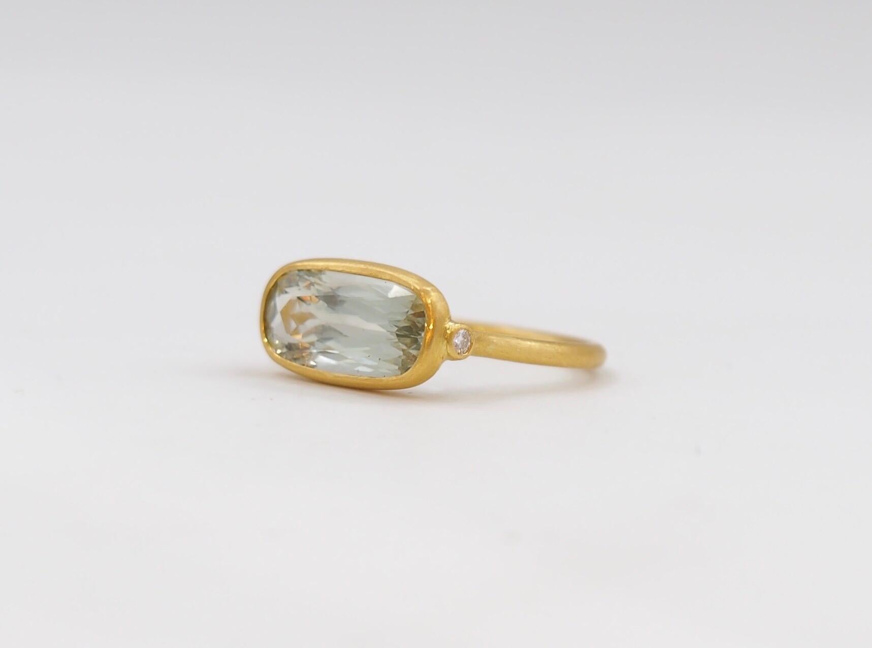 This delicate ring by Scrives is composed of a faceted Green Amethyst of 3.5 cts and 2 small white diamonds on the side. 
The green Amethyst does not exist in nature. This stone had colour treatment. The colour is light green and the light is