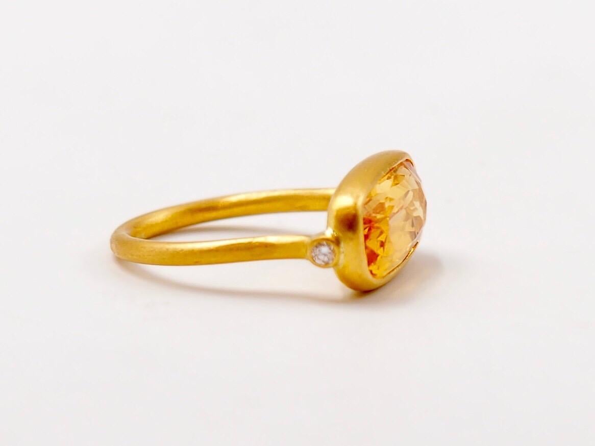 This delicate ring by Scrives is composed of a faceted citrine of 3.65cts and 2 small white diamonds on each side of the citrine. It has been made for the pinky finger but can be adapted if needed.

The stone is a natural citrine with no treatment.