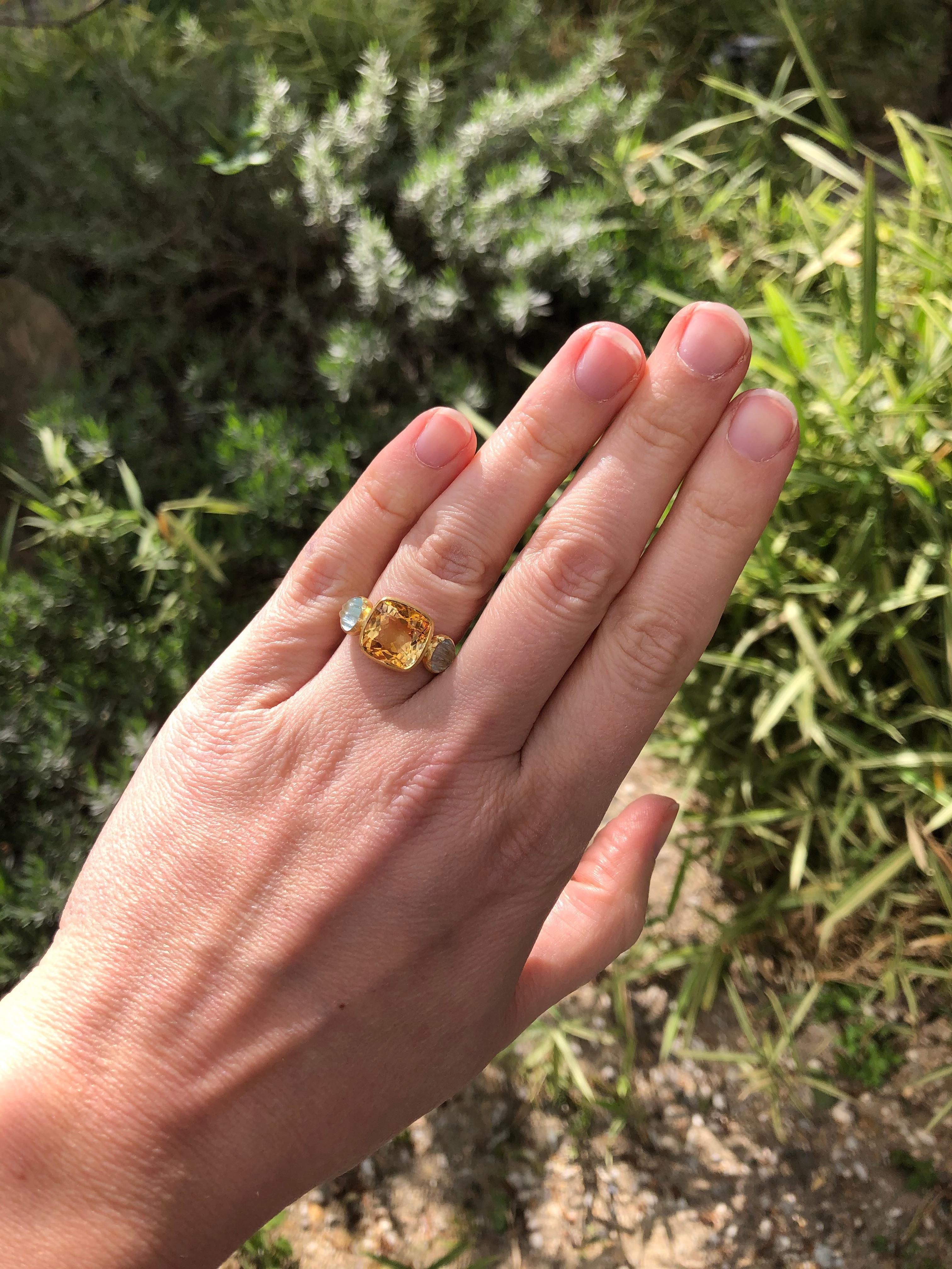This delicate ring is composed of citrine facated of 4.53 cts surrounded by 2 aquamarines carved as shells (totale weight: 1.44cts). The stones show natural, typical and eye-visible inclusions. 

This one-of-a-kind ring is handmade with 22kt mat