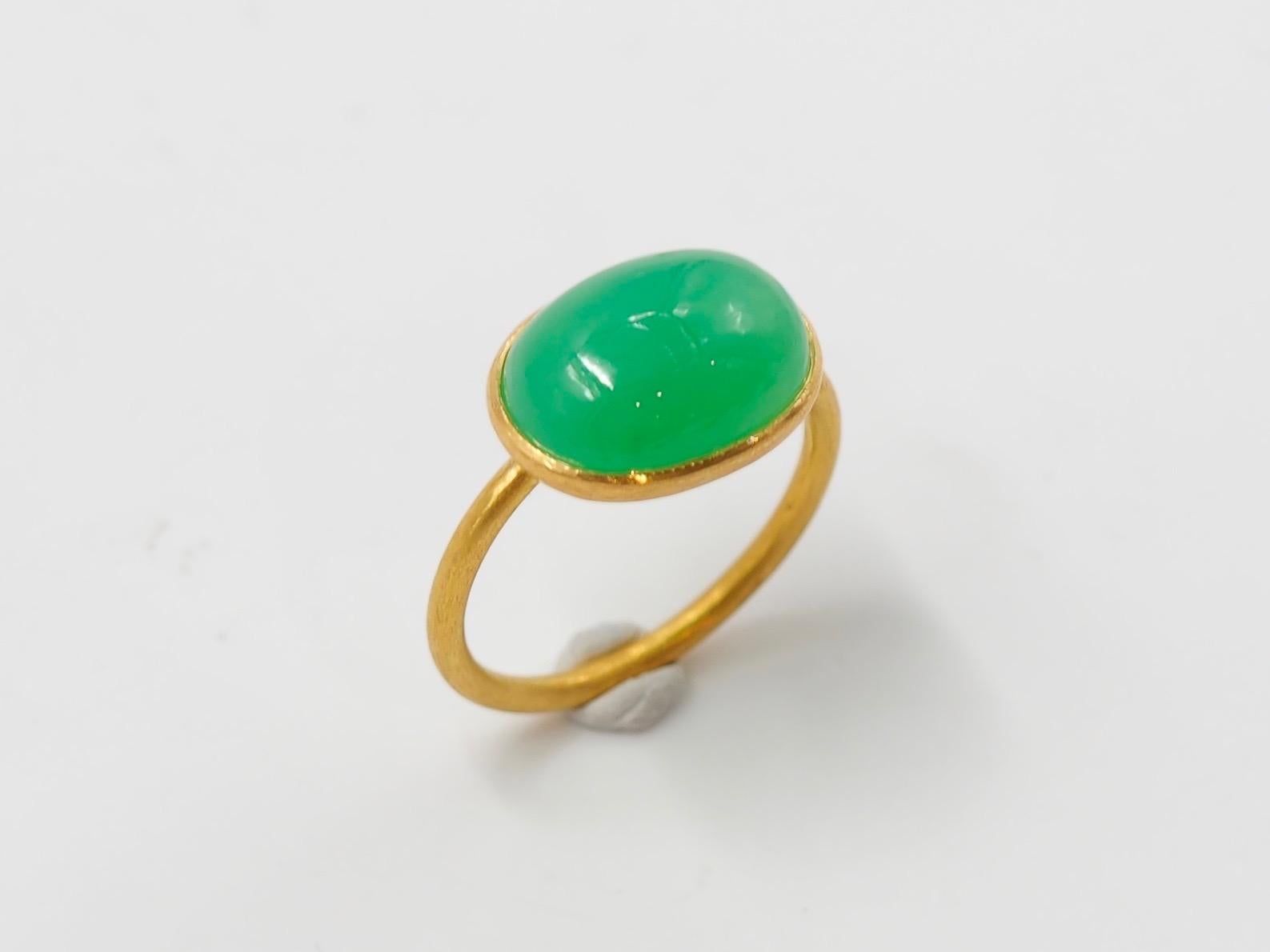 This simple ring by Scrives is composed of a large green chalcedony cabochon of 5.93 cts. 
The stone is set in a 22kt closed gold setting.
This chrysoprase is natural, not dyed and has natural & typical small inclusions.

This ring is handmade with
