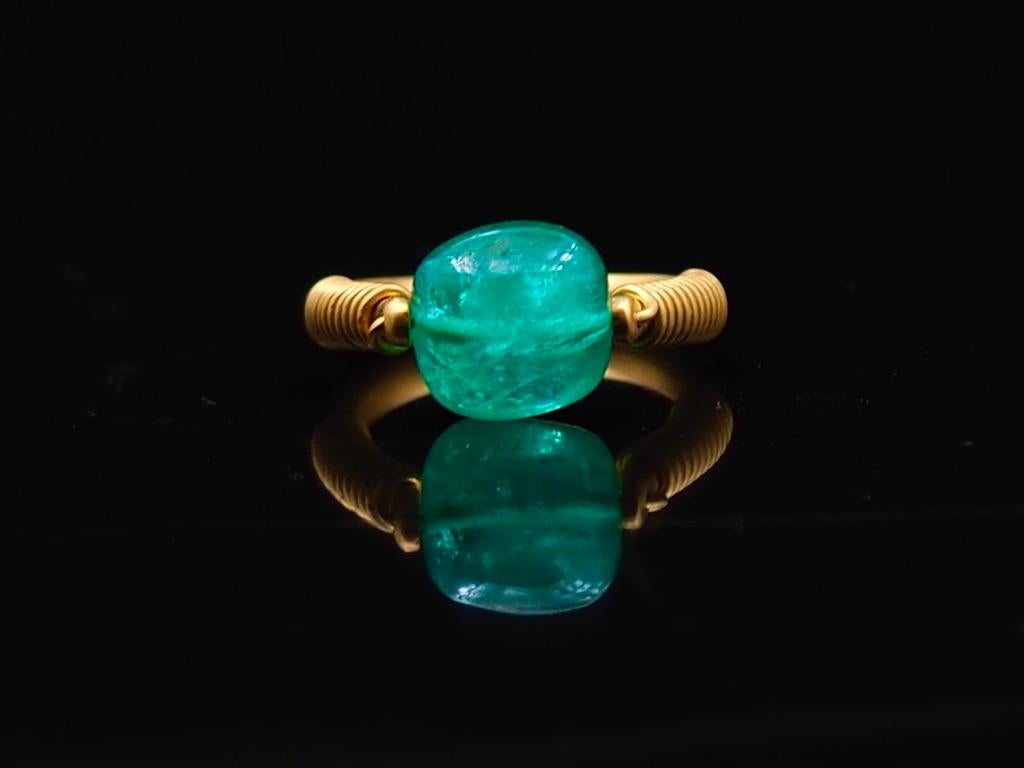 This antic style ring by Scrives is set with a large tumble emerald of 6.09 cts. The stone is natural with no treatment beside oil presence (oil is necessary to carve emeralds). It shows visible natural inclusions. 
The emerald origin is Colombia.