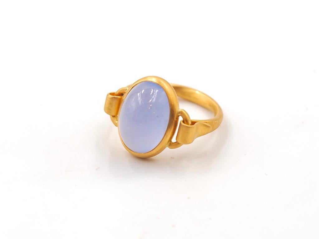 This delicate ring is composed of an intense and large blue chalcedony of 8.18 carats (origin Africa). The blue chalcedony is natural with inclusions. 
The stone and its setting are moving, not fixed to the band, which gives an extra comfort wearing