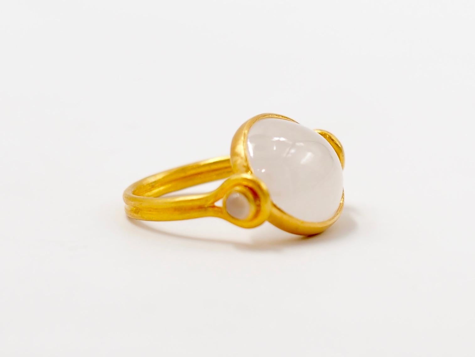 This antic style ring by Scrives is set with a large white jade / jadeite cabochon of 9.76 cts. The pure white colour of the jade gives light and brightness to the ring. 
The stone is natural and not treated. 
The central stone and its setting are