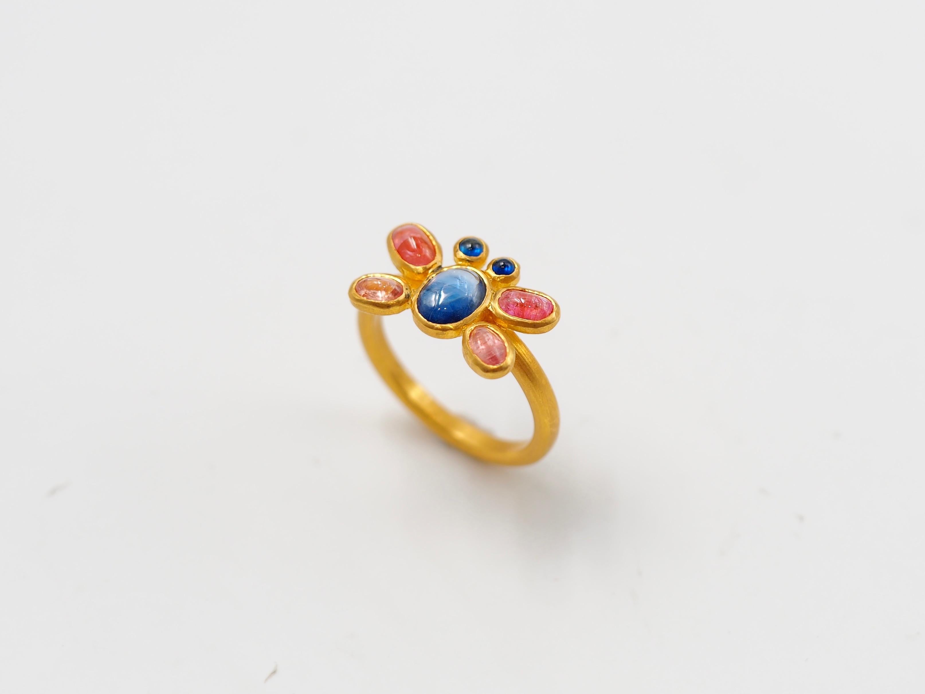 This one-of-a-kind ring by Scrives is composed of 7 sapphires (total weight of 1.42 cts, unheated from Sri lanka). Colours of sapphires are blue, orange & peach. All stones are cabochons & have different shapes. 

The stones are set in gold (closed