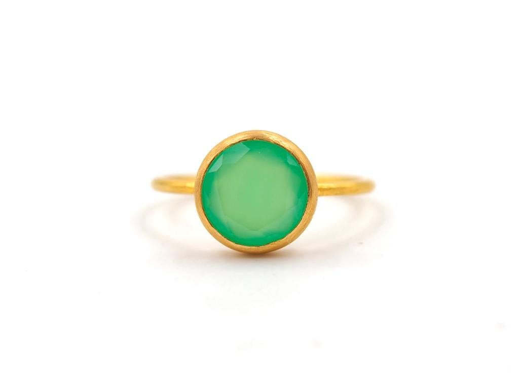 This simple ring by Scrives is composed of a round green chalcedony . 
The stone is set in a 22kt closed gold setting.
This chrysoprase is natural, not dyed and has natural & typical small inclusions.
You can stack more than one ring like you can