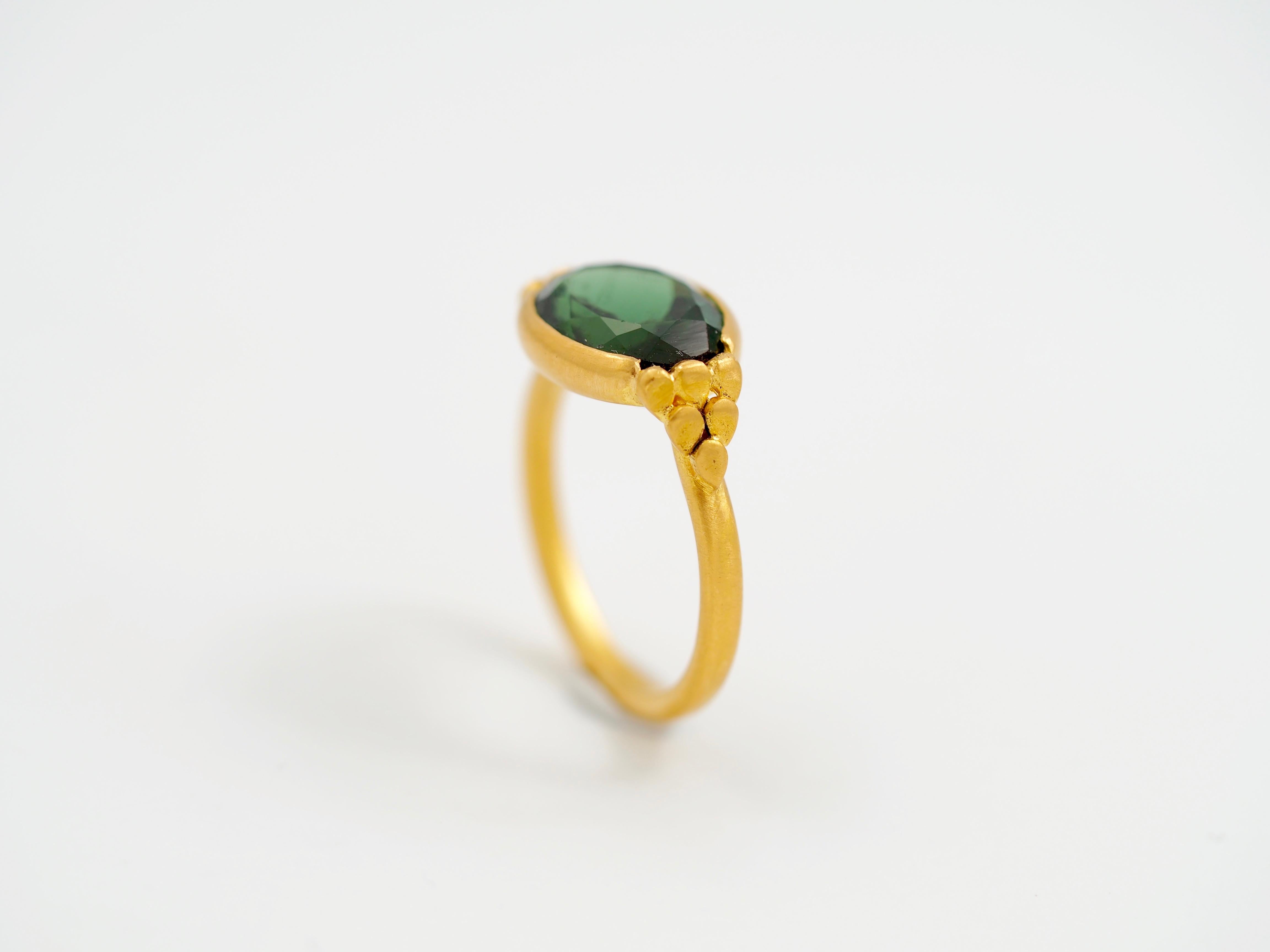 This delicate ring by Scrives is composed of a deep green tourmaline (forest green) of 4.36cts. The tourmaline is slightly showing 2 different greens. On both sides, the green is turning toward green yellowish. Whereas at the center, the green is