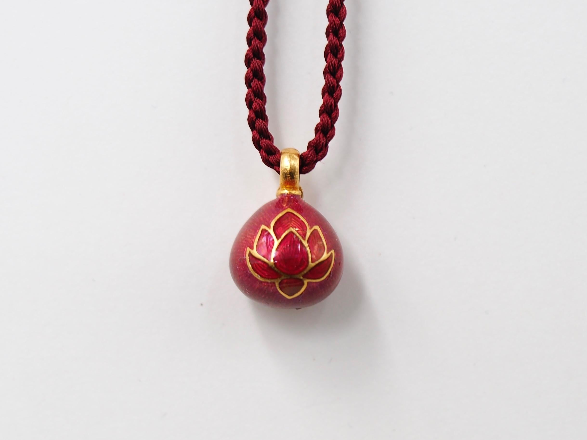 This one-of-a-kind pendant by Scrives is composed of pink tourmaline set in a 23kt gold similar shape covered with a matching pink, hot and transparent enamel (Mina Kari) representing a lotus flower in a red enamel. Above the tourmaline, a small