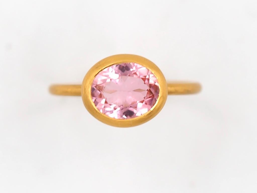 This simple ring by Scrives is composed of an oval pink tourmaline. 
The stone is set in a 22kt closed gold setting.
This tourmaline is natural, not treated and has natural & typical small inclusions. 
You can stack more than one ring like you can