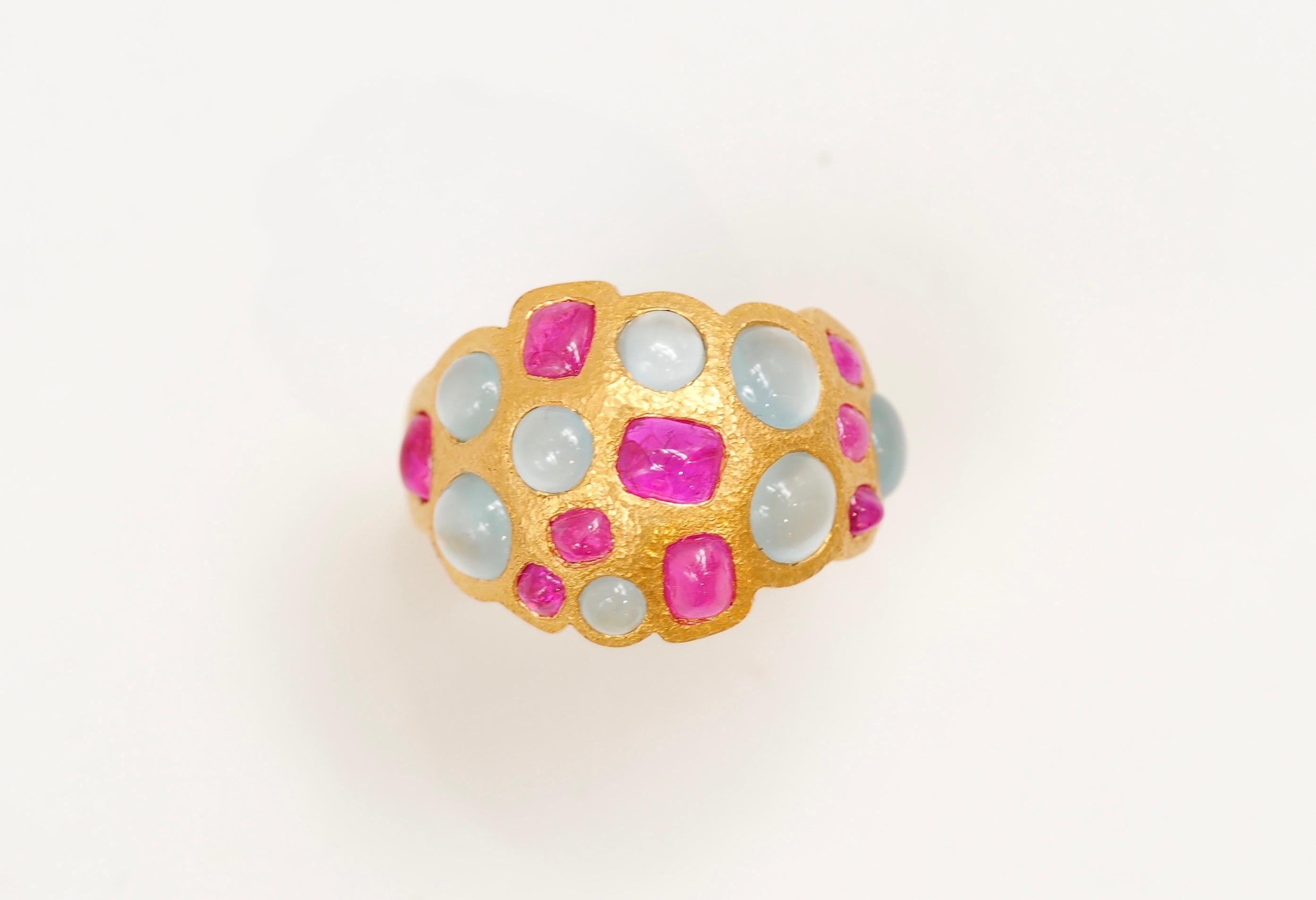 This colourful and irregular band ring is hand-hammered and set with 9 natural rubies sugarloafs for a total weight of 2.97cts & 8 cabochons of aquamarine (total weight: 2cts).
The stones can exhibit visible natural and typical inclusions. 

The