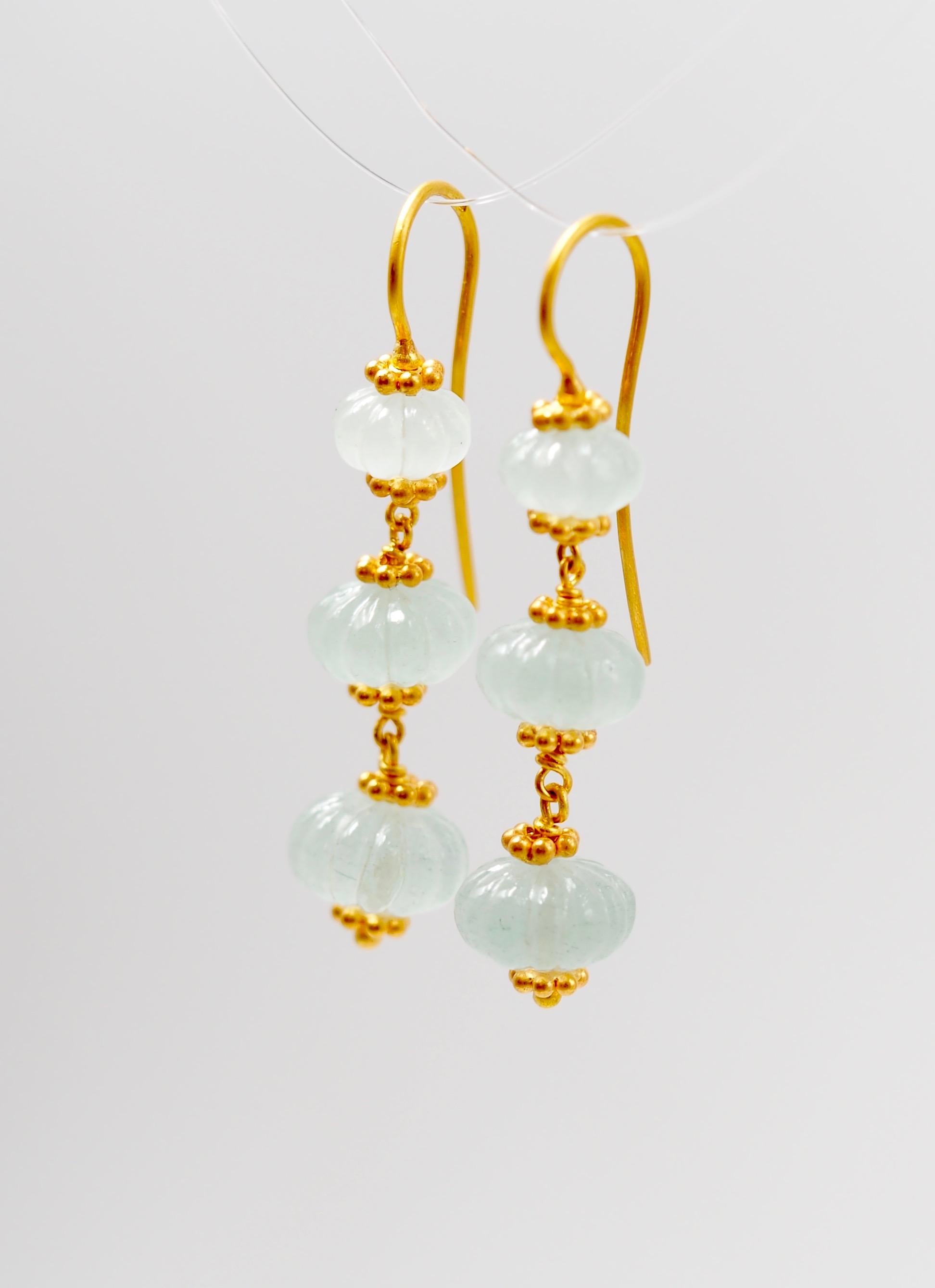 These earrings by Scrives are made of 6 watermelon shape beads of translucent greenish aquamarine for a total weight of 17.38 cts.
The watermelons show decreasing sizes. 
The same earrings exist also in lapis lazuli and in amethyst.

This