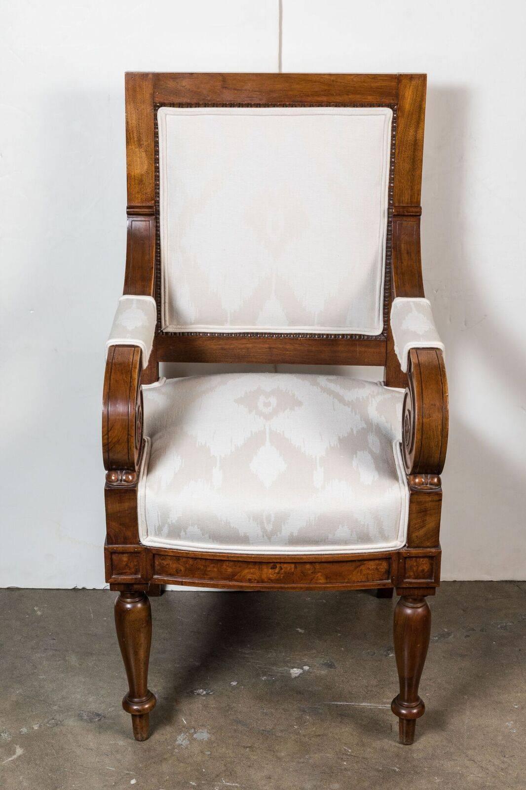 Pair of Liberty Period, beautifully carved, solid Chestnut side chairs with unique, tightly scrolled arms featuring radiant, floral reliefs in the center of each.