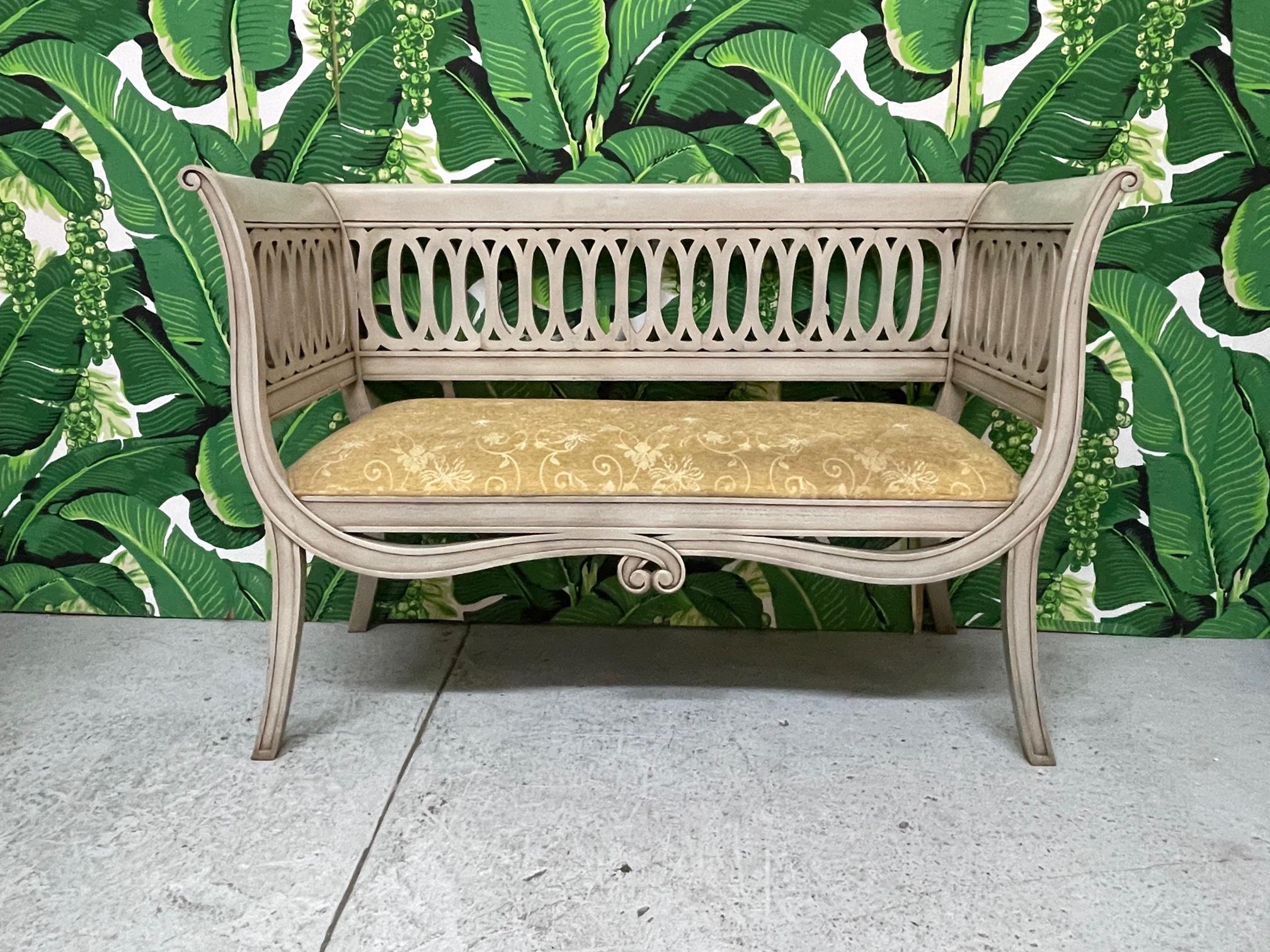 Regency style bench features a scrolled frame and sabre legs. Upholstered in a vintage tone on tone fabric. Finish appears to be original. Good condition with minor imperfections consistent with age.

 