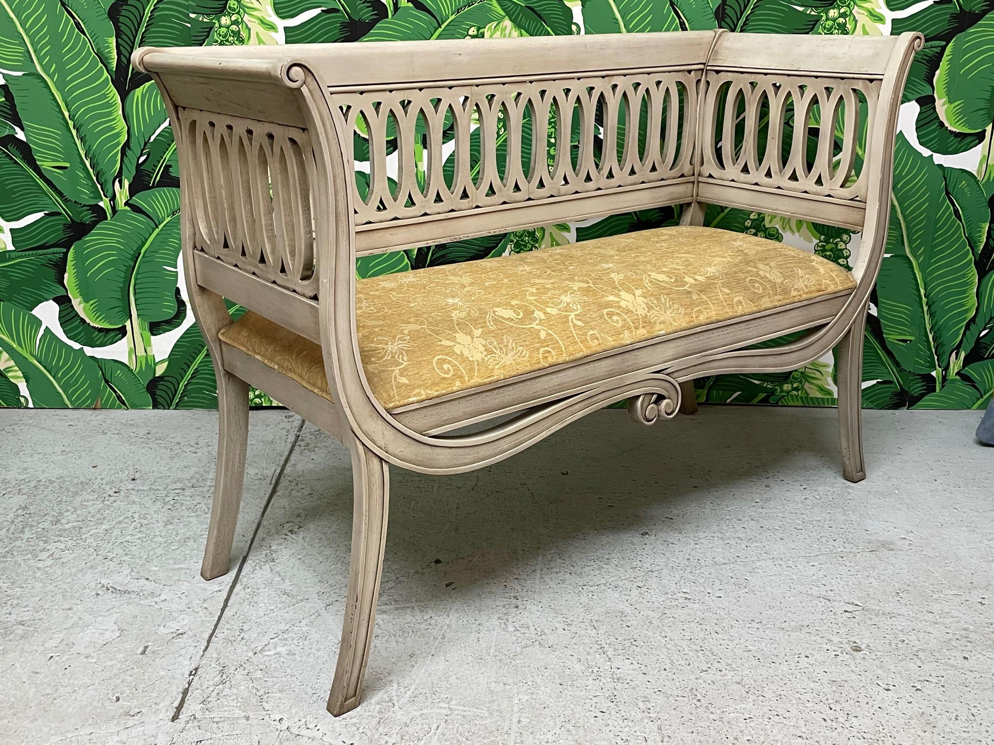 Regency style bench features a scrolled frame and sabre legs. Upholstered in a vintage tone on tone fabric. Finish appears to be original. Good condition with imperfections consistent with age some light staining on fabric, see photos for condition