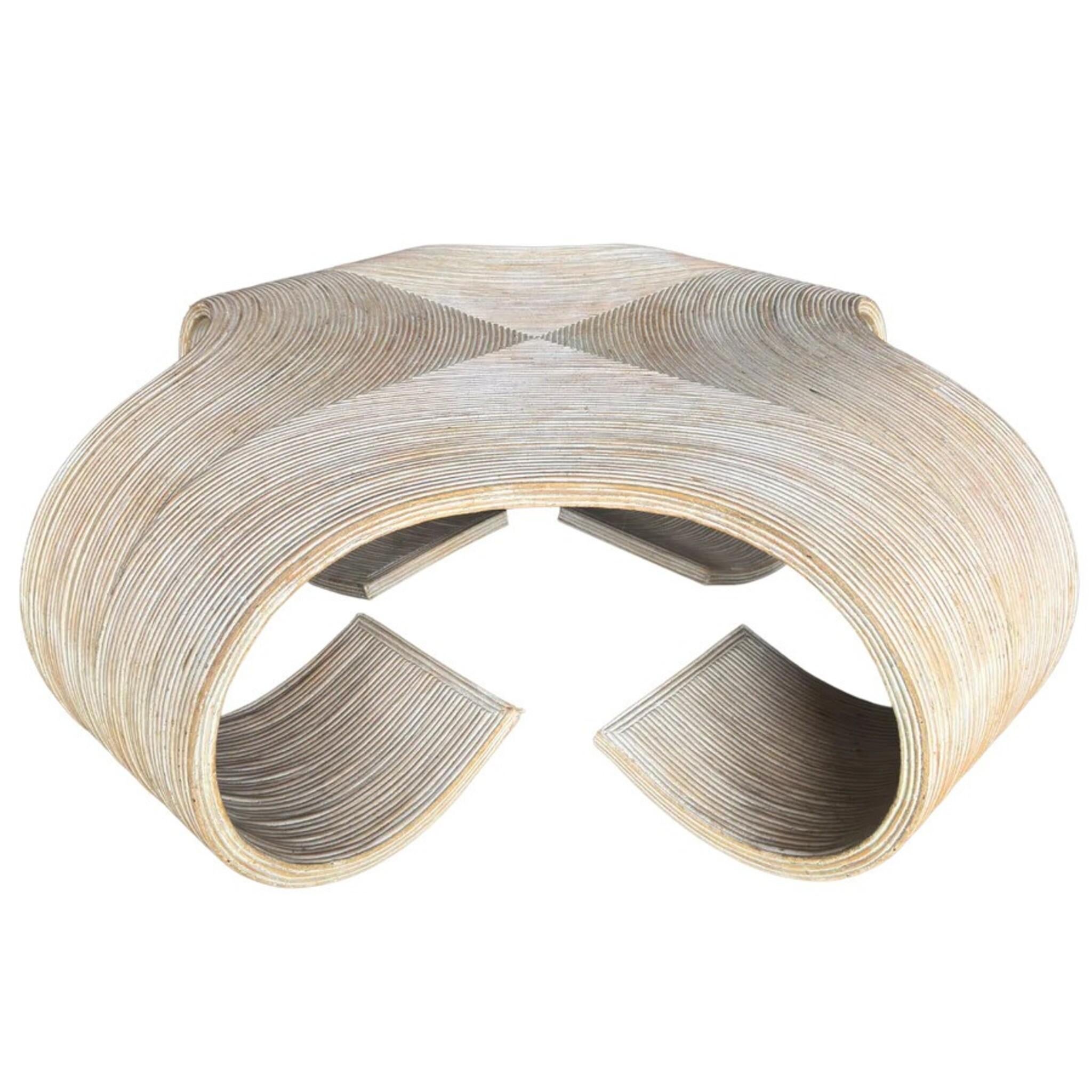 Sculptural Italian coffee table from the 1970s composed of tightly wrapped pencil bamboo over a curved wood form. The silhouette curls into wide scrolled legs, creating an open base with a strong sense of movement and lightness. Finished in a pale