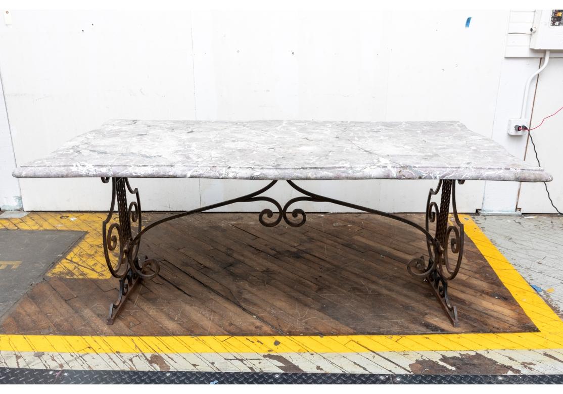 A large and refined Stone top table with Lyre form Iron base with fine form and color. Rectangular with lyre form supports and scrolled stretcher having a beveled and scalloped marble top.

L. 59