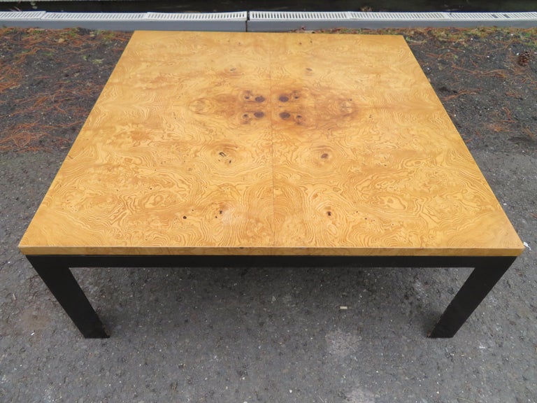 Scrumptious Milo Baughman style burl wood and black square coffee table. We love the contrast between the light burl wood against the ebonized black legs-very stylish. This table measures 16