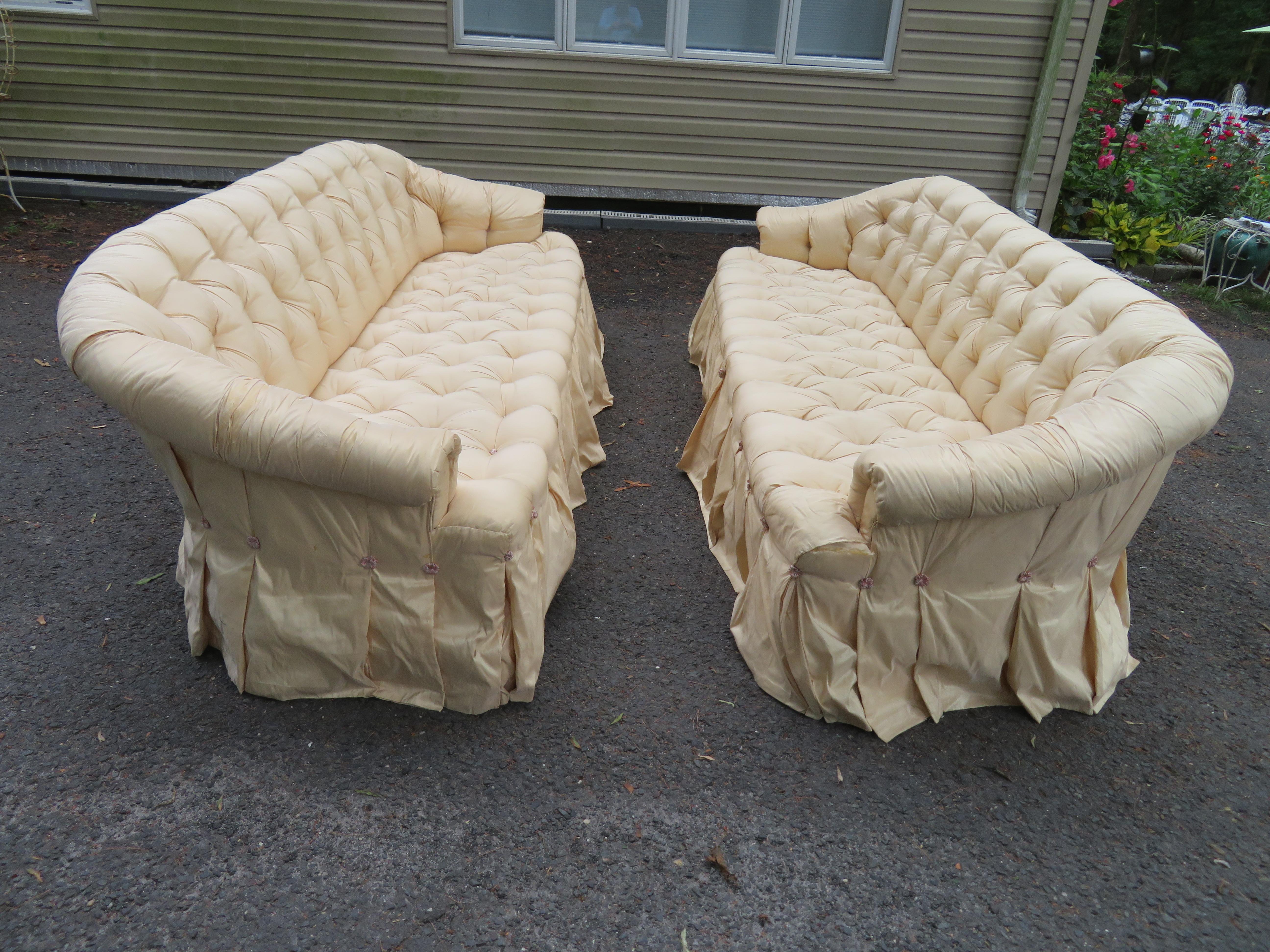 Scrumptious pair of Hollywood Regency tufted and skirted sofas-Ohhhh la la! These are really fabulous! The silk fabric dress will need to be replaced but the sofas are done in muslin underneath. The foam is still in great shape!