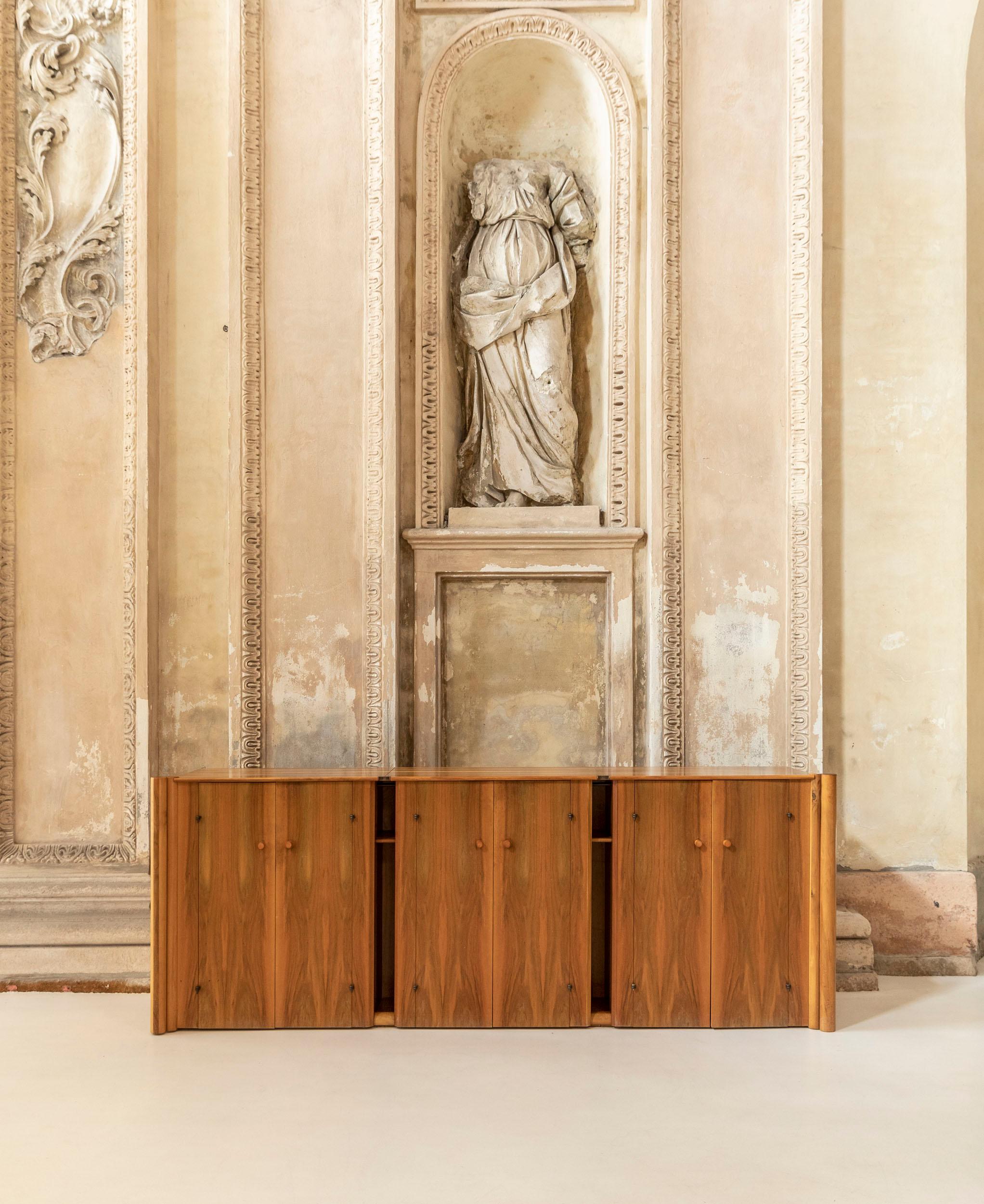 Walnut sideboard by Carlo Scarpa for Bernini.
Three different pieces with front horizontal open of the six doors with double cylindrical elements side by side. Two pieces present two shelves, one has one shelf and three